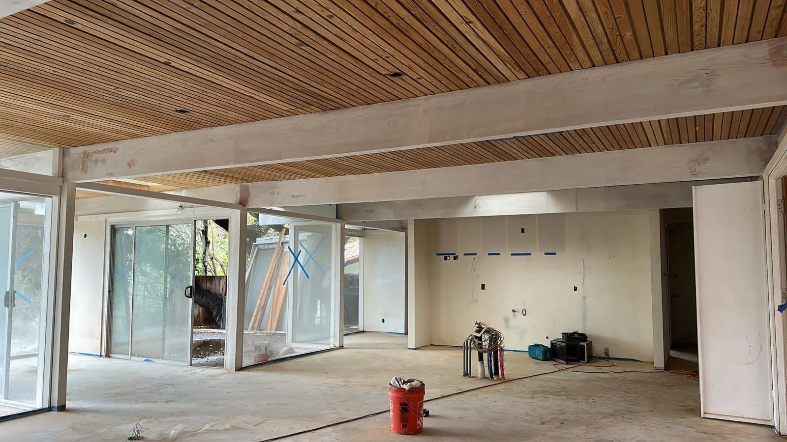 Hollywood Hills mid-century home in progress with open floor plan, exposed beams, and layout prepared for kitchen and living integration