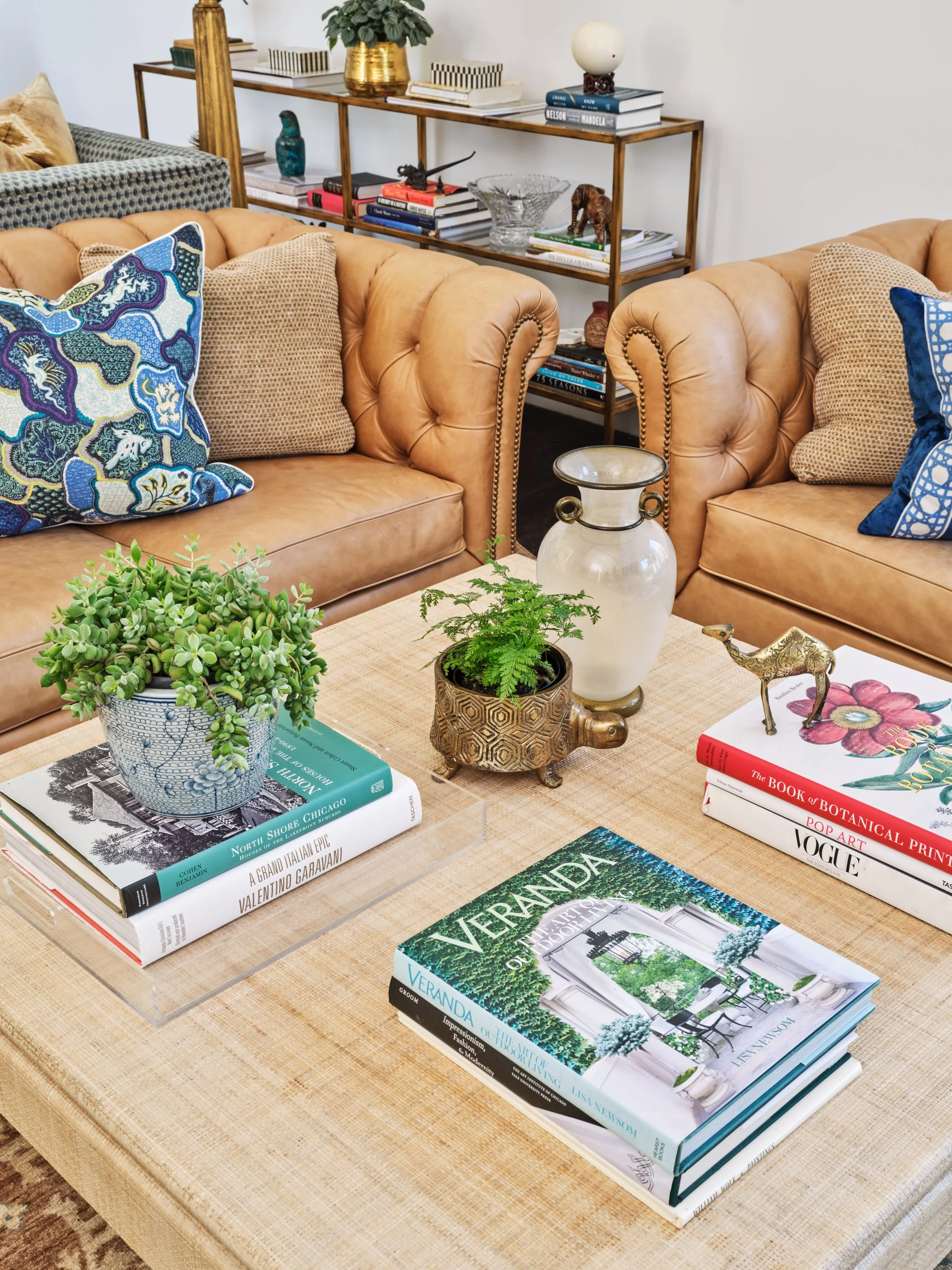 Malibu custom home living room detail with leather armchairs, styled coffee table, curated books, and refined interior finishes by Heart Construction