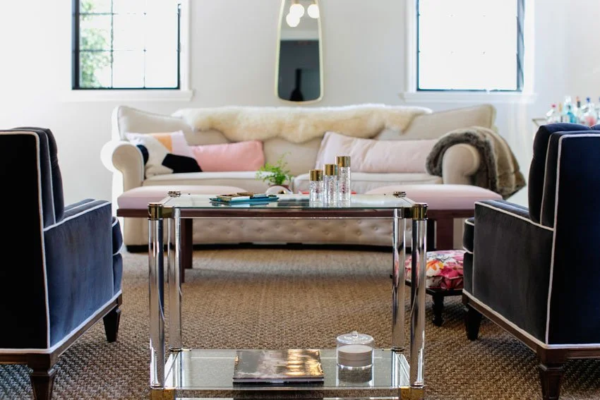 Living room seating area with glass coffee table, velvet armchairs, and soft neutral tones in Hancock Park remodel