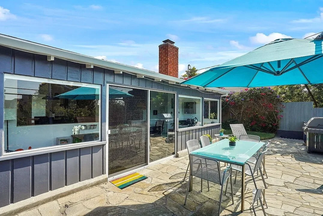 Before – rear exterior showing original structure with segmented layout and enclosed living spaces