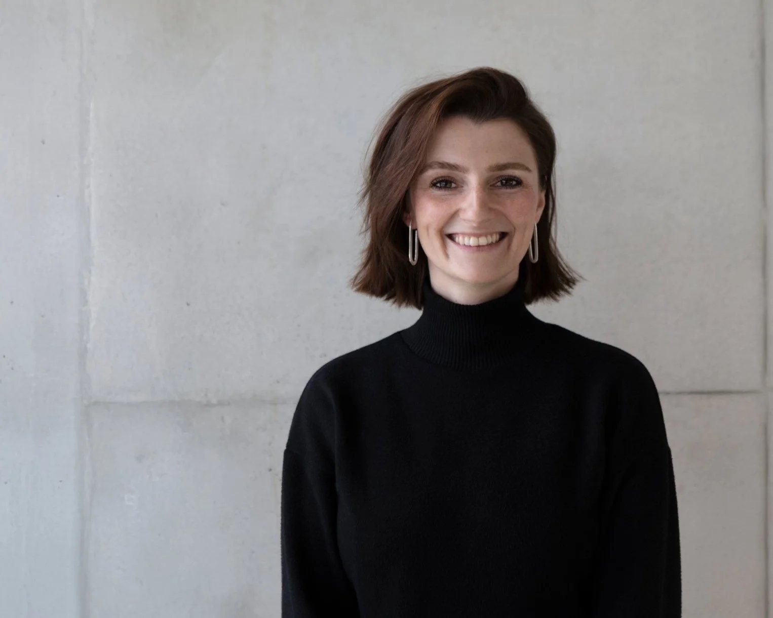 Portrait of jewellery designer Constanze Chrosch wearing contemporary handcrafted silver earrings.