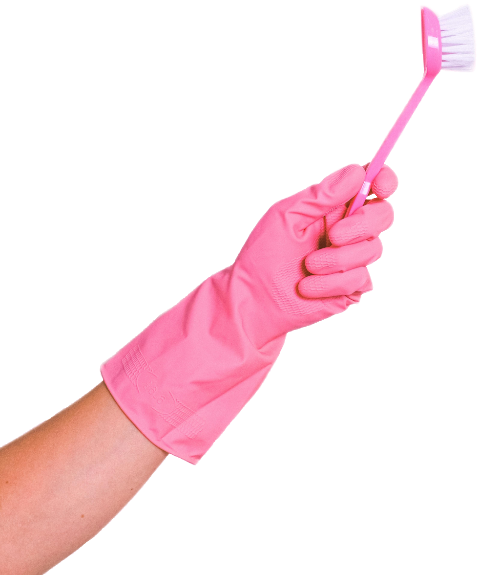 Hand wearing a pink rubber cleaning glove holding a pink scrub brush against a black background.