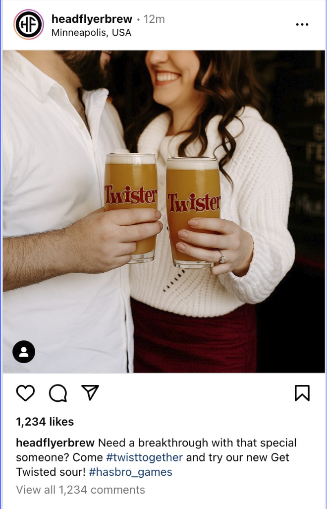 A man and woman smiling and holding glasses of Twisted beer in a social setting.