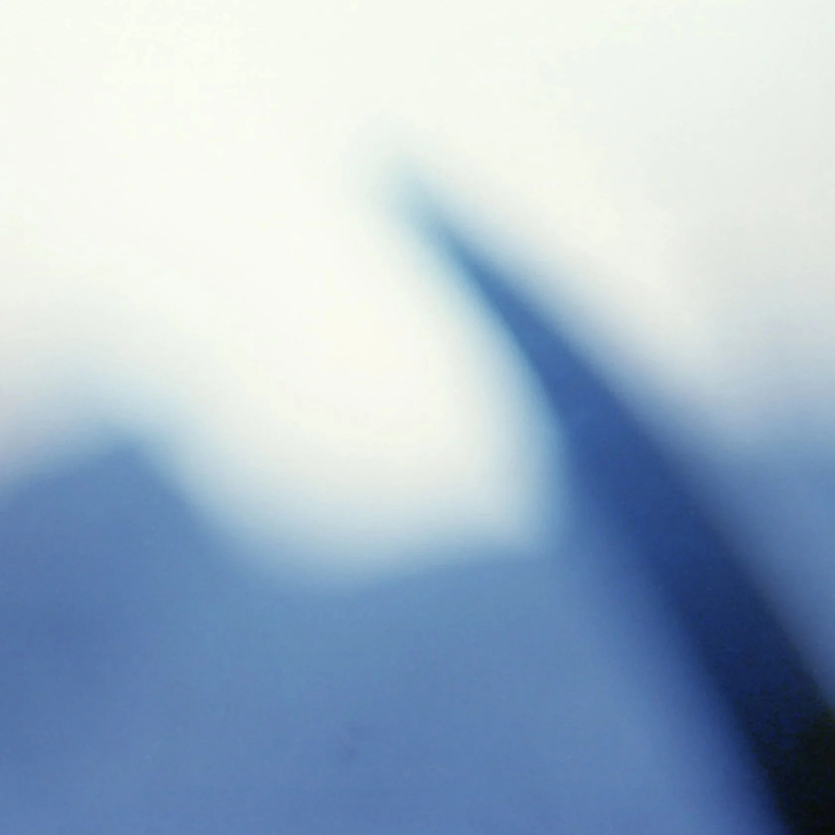 Blurred blue and white abstract background with soft gradient.