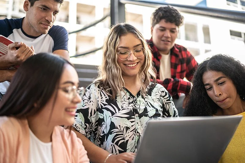 Young people looking at a computer