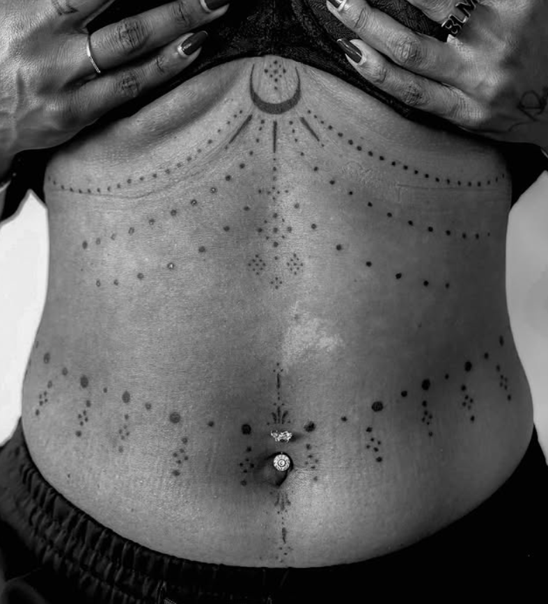 Ornamental tattoo on women's sternum and stomach.
