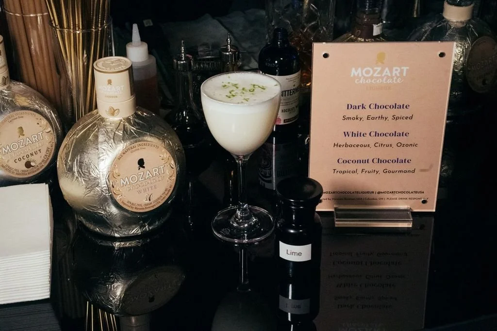 For Mozart Liqueur.

 White Chocolate
 Mint
 Lime
 White Rum
 Egg White