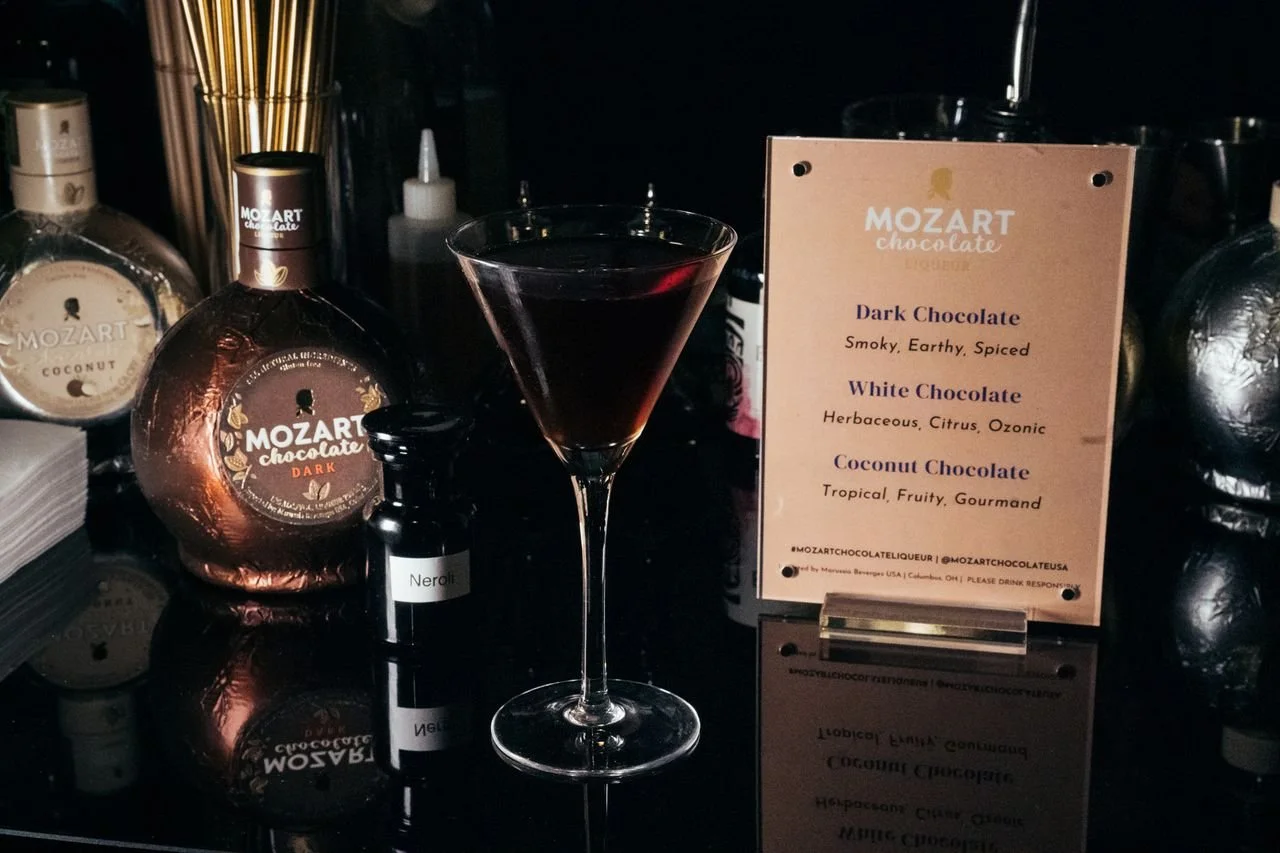 For Mozart Liqueur.

 Dark Chocolate
 Orange Blossom
 Mole Bitters
 Tequila
 Mezcal