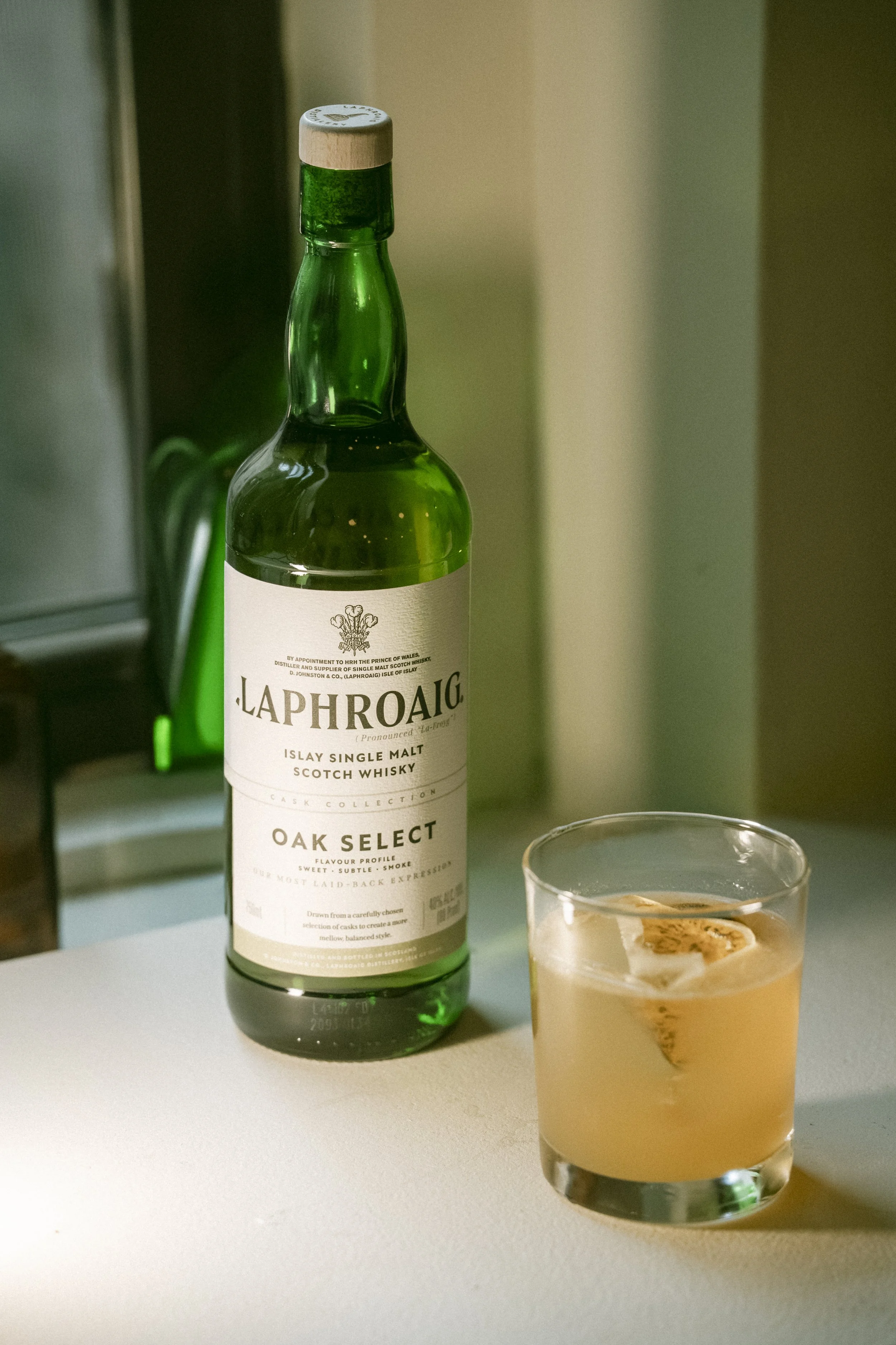 For Laphroaig.

 Ginger Root
 Bergamot
 Hojicha
 Lemon
 Honey
 Laphroaig Oak Select