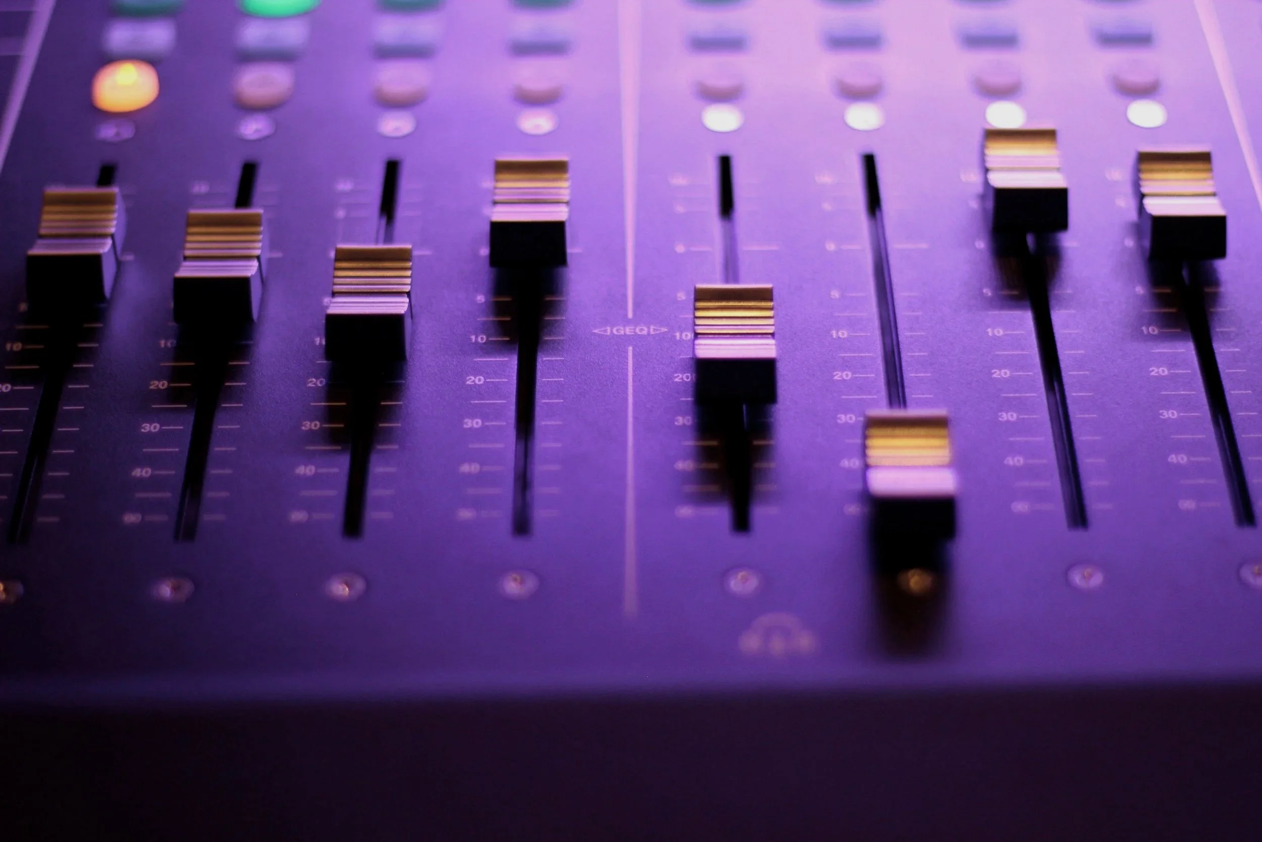 A closeup image of a wave in the ocean. The sky is a muted sunset.