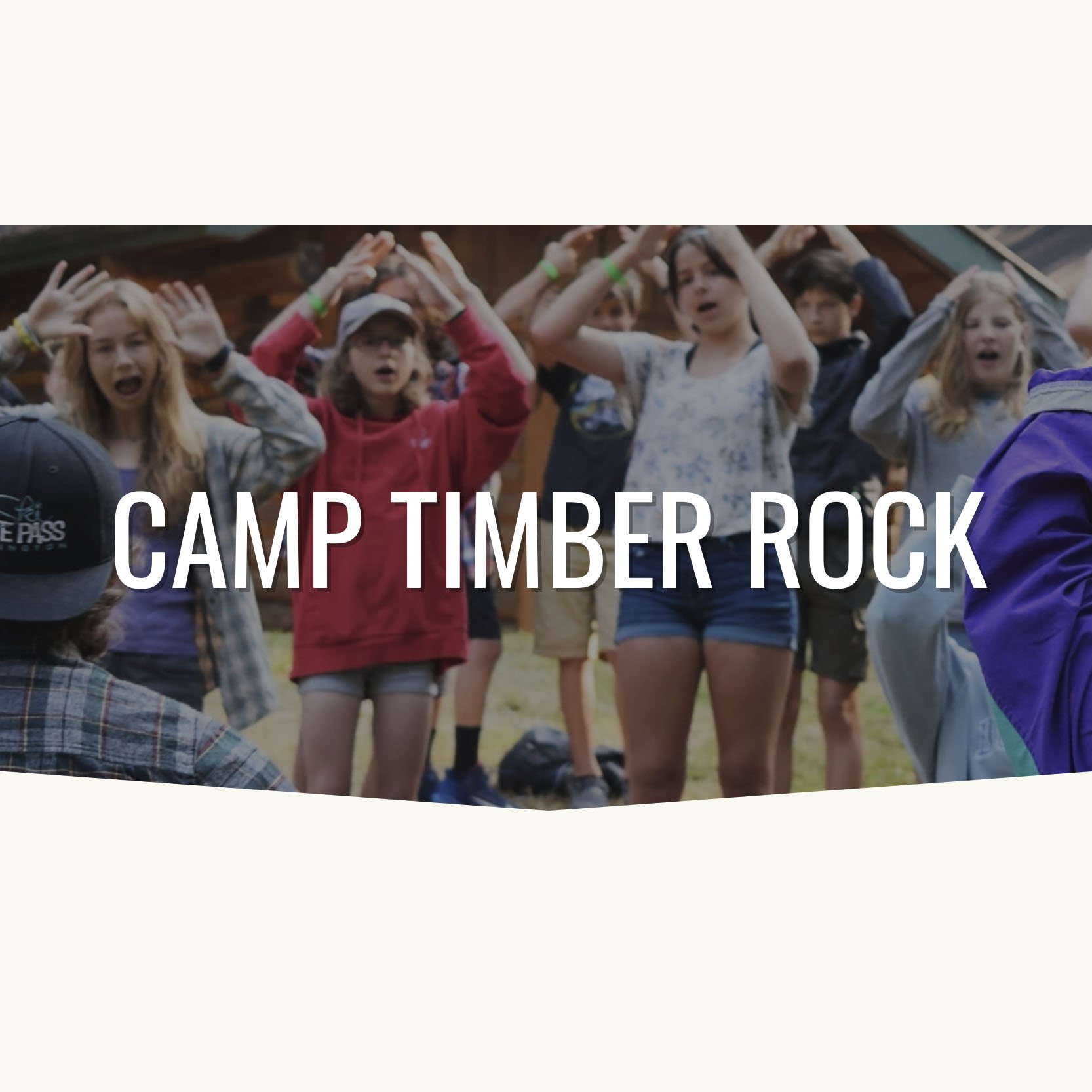 A group of middle school kids are singing and raising their hands to follow motions of the leader.