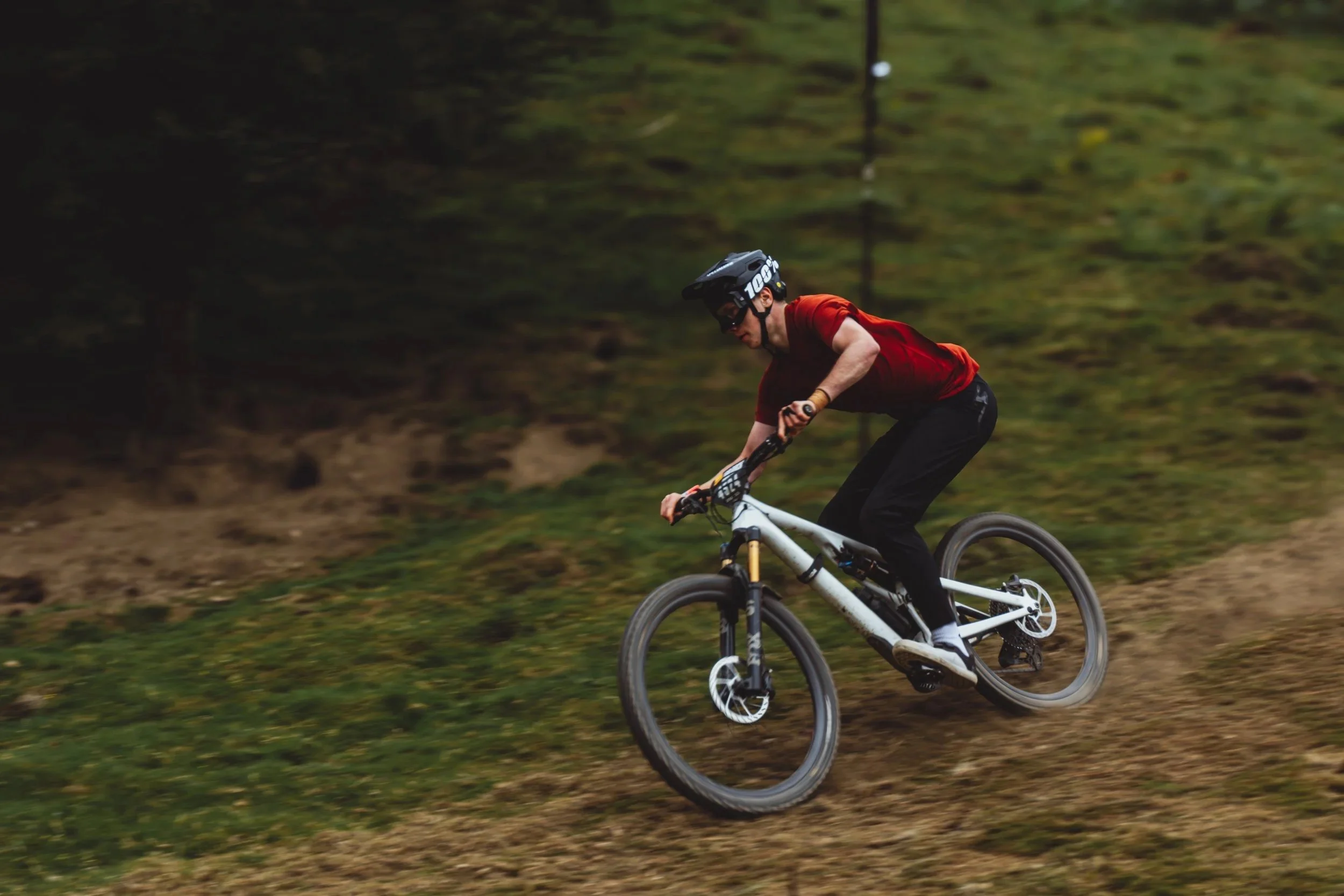 Mountain biker racing downhill, North Yorkshire, UK