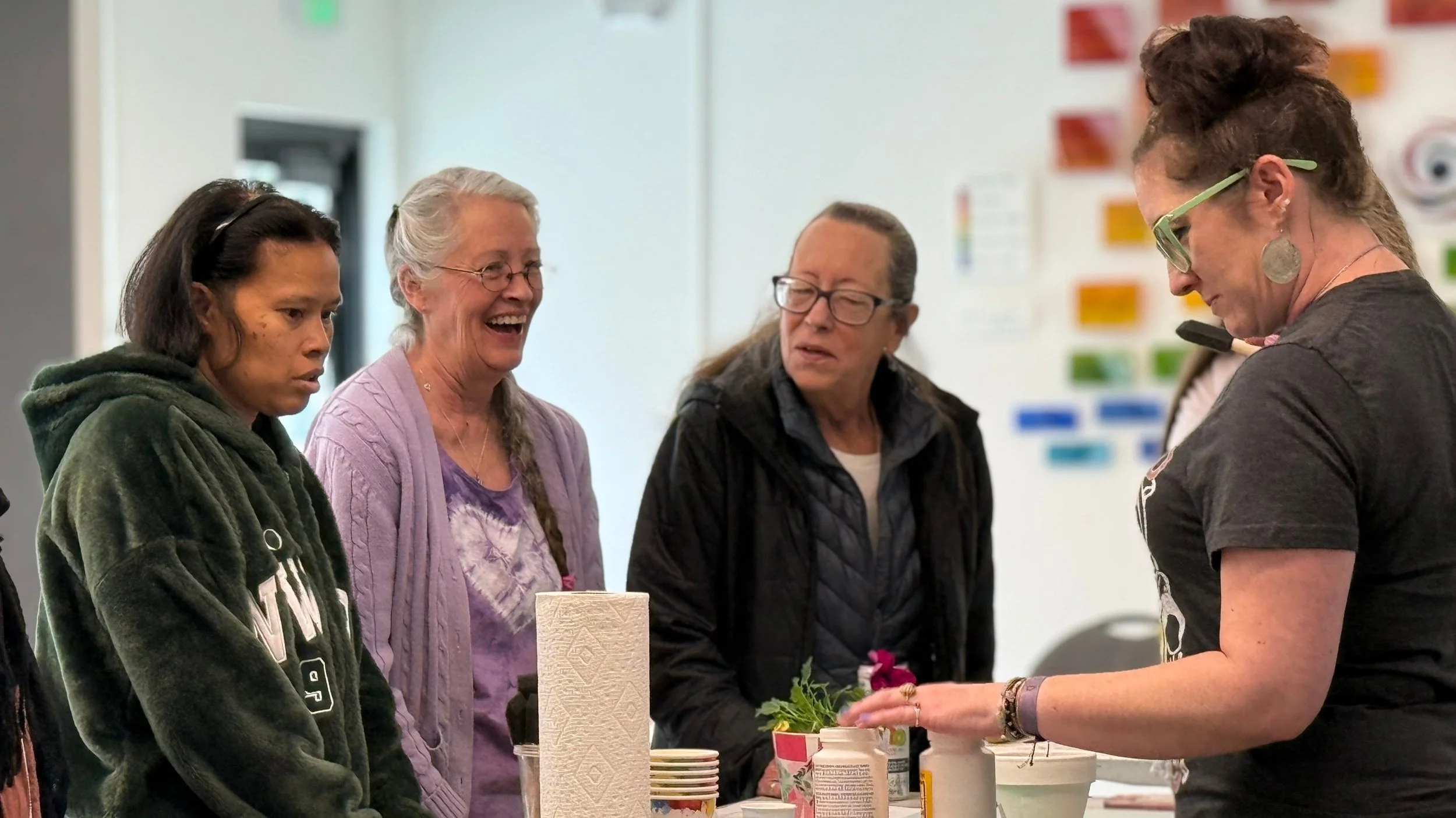 A group of four adults participating craft building organized by Center for the Arts Evergreen