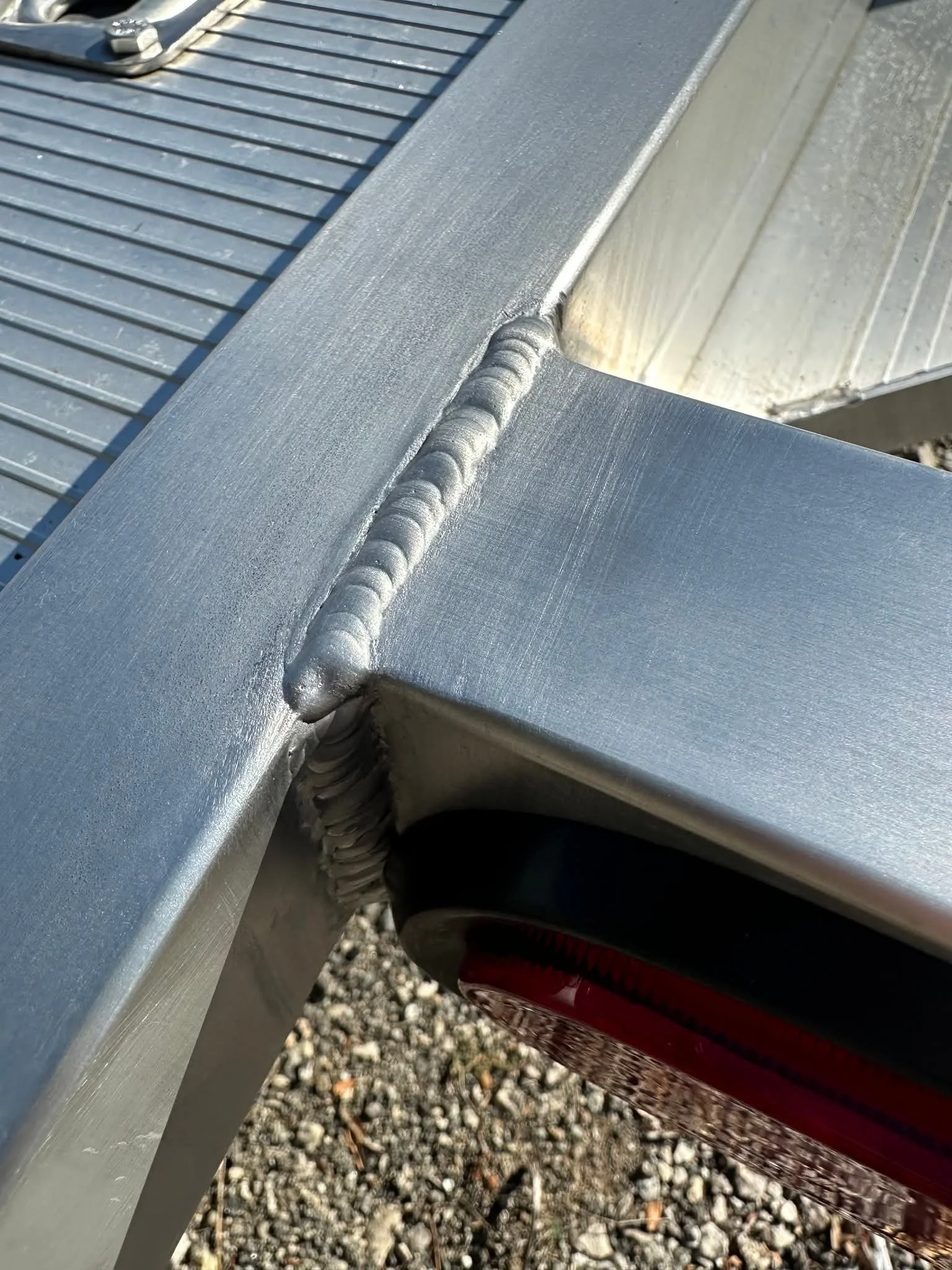 Close-up of clean TIG welds on custom aluminum fabrication.