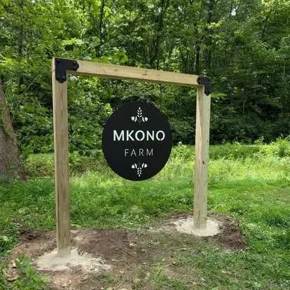 Custom hanging metal farm entrance sign for Mkono Farm.