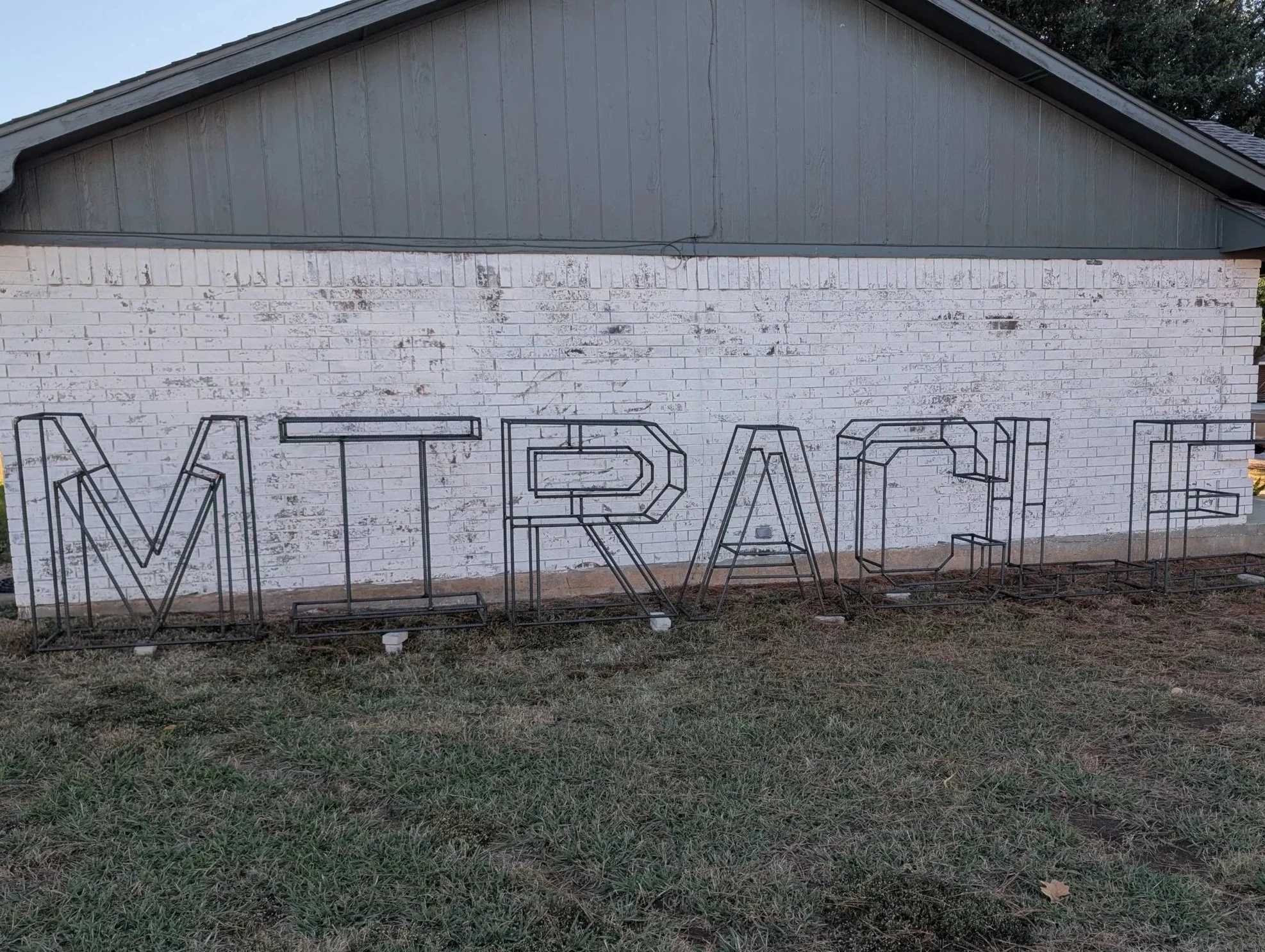 Large-scale custom metal letter sign fabricated from precision-formed steel for an outdoor display. Each letter features an open-frame design for durability, clean lines, and consistent spacing. This custom steel signage was designed and built for lo
