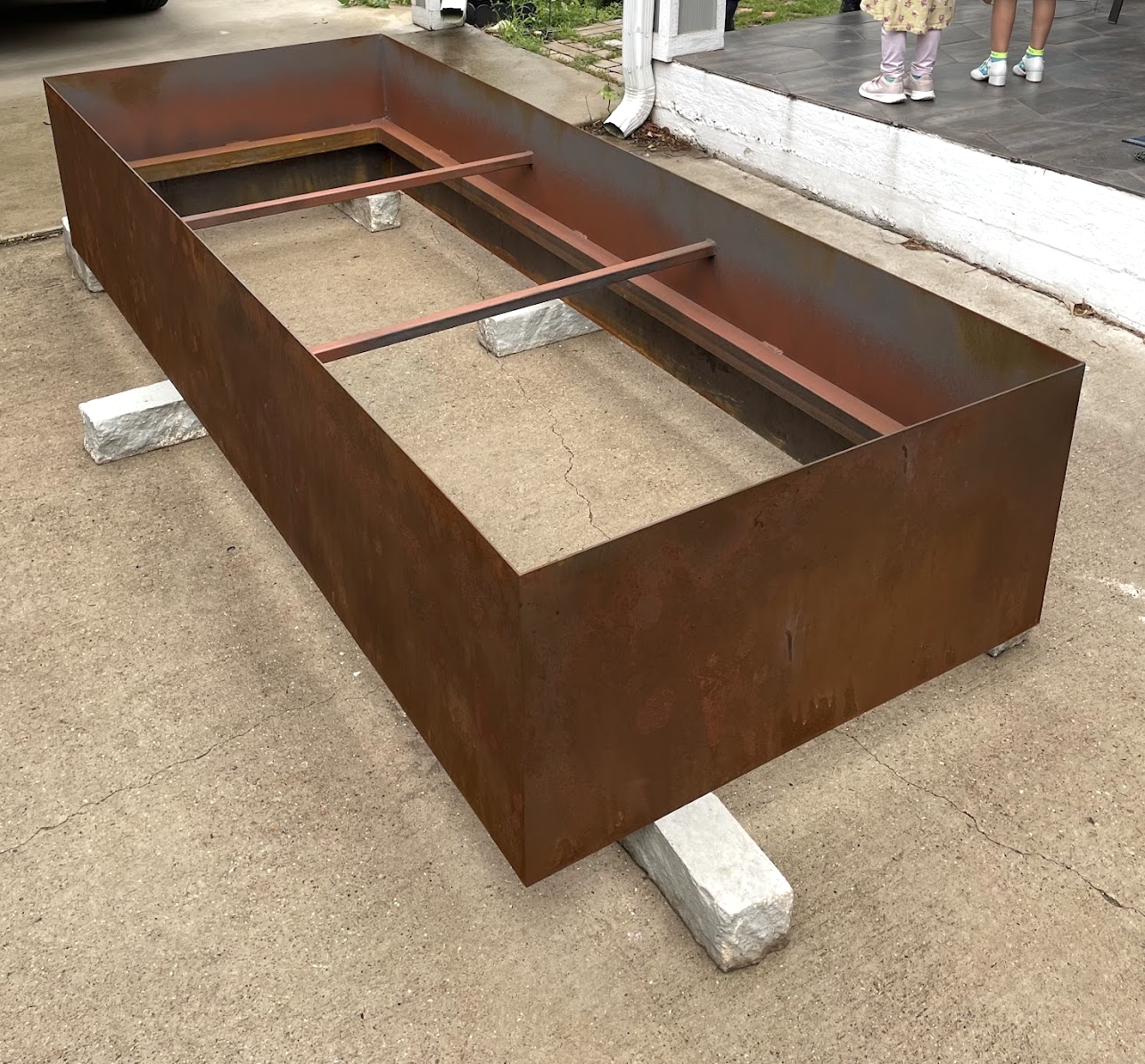 Set of custom fabricated rusted steel planters for outdoor landscaping in North Texas.