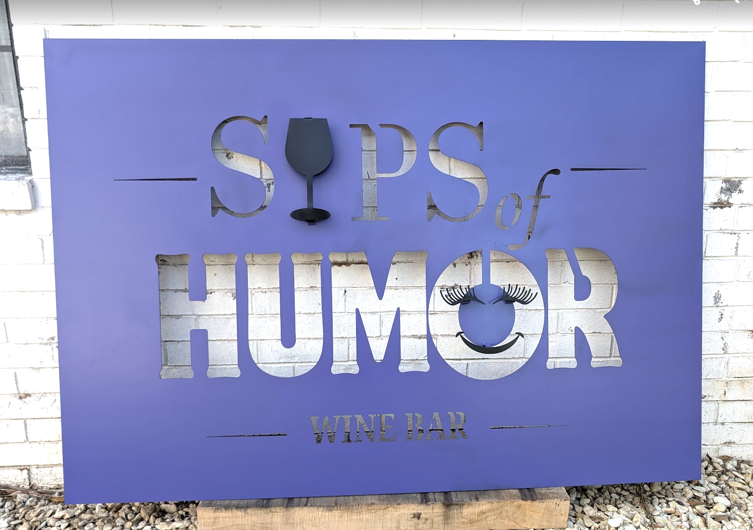 Custom CNC plasma-cut metal sign for Sips of Humor Wine Bar.