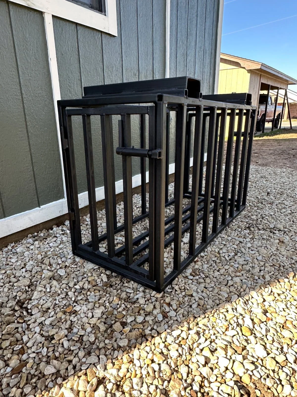 Side view of custom livestock handling chute fabricated from welded steel.