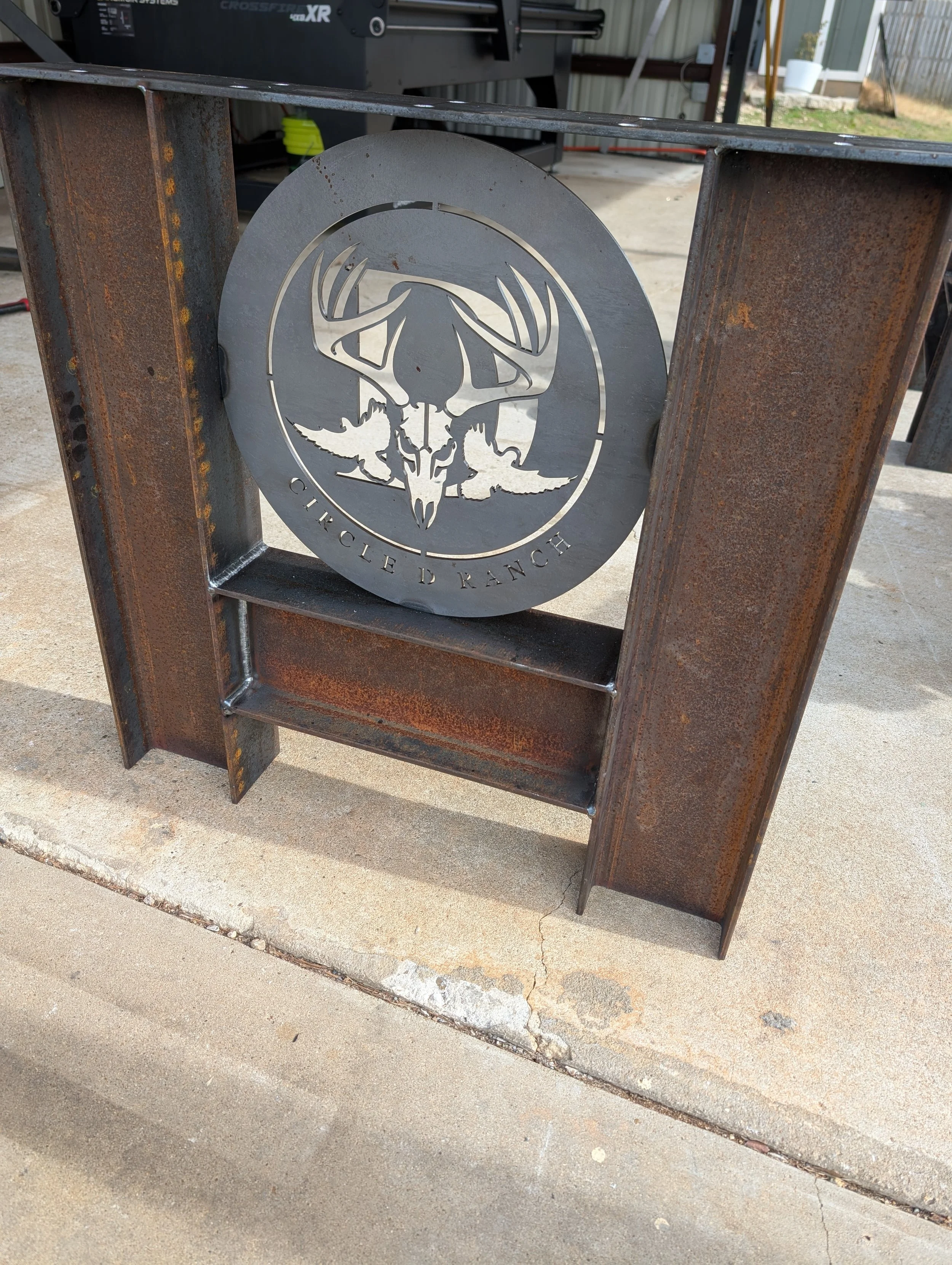 Custom steel table base with personalized Circle D Ranch metal insert fabricated by JH Tig Works LLC in North Texas