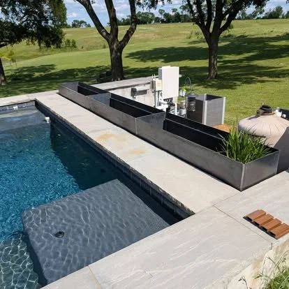 Rust-finished custom steel planters fabricated for residential outdoor landscaping.