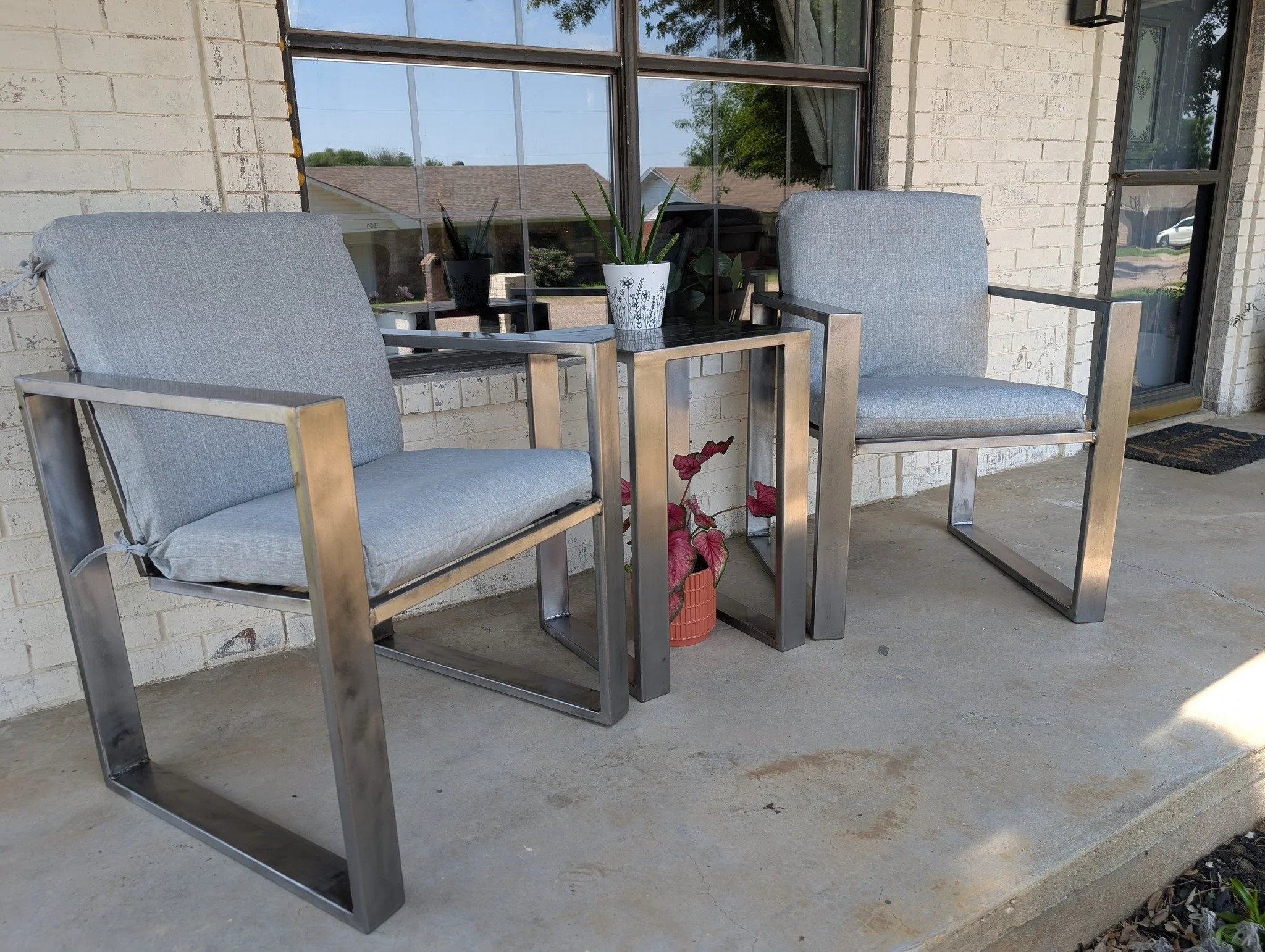 Custom steel patio chairs and matching side table fabricated by JH Tig Works LLC in North Texas