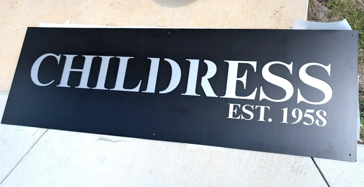 Custom black steel Childress EST. 1958 metal sign fabricated with CNC plasma cutting.