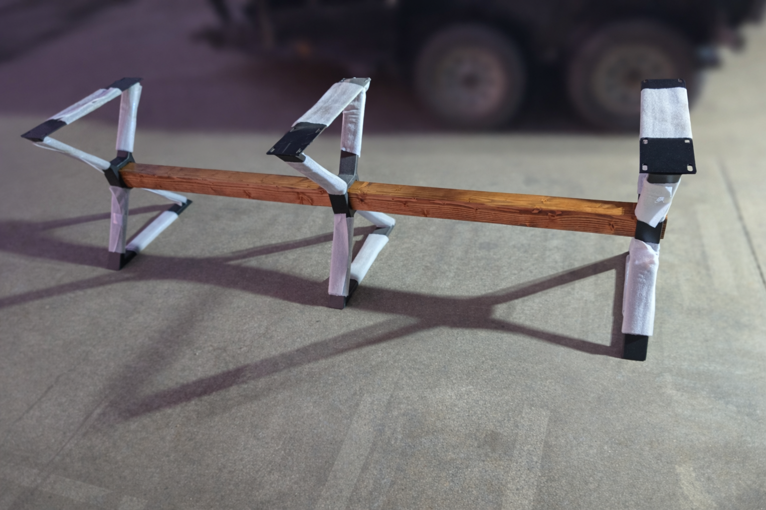 Custom powder-coated steel table legs featuring a modern geometric design with an integrated solid wood beam. Built for strength, stability, and a bold industrial aesthetic to support solid wood table tops in custom furniture projects.