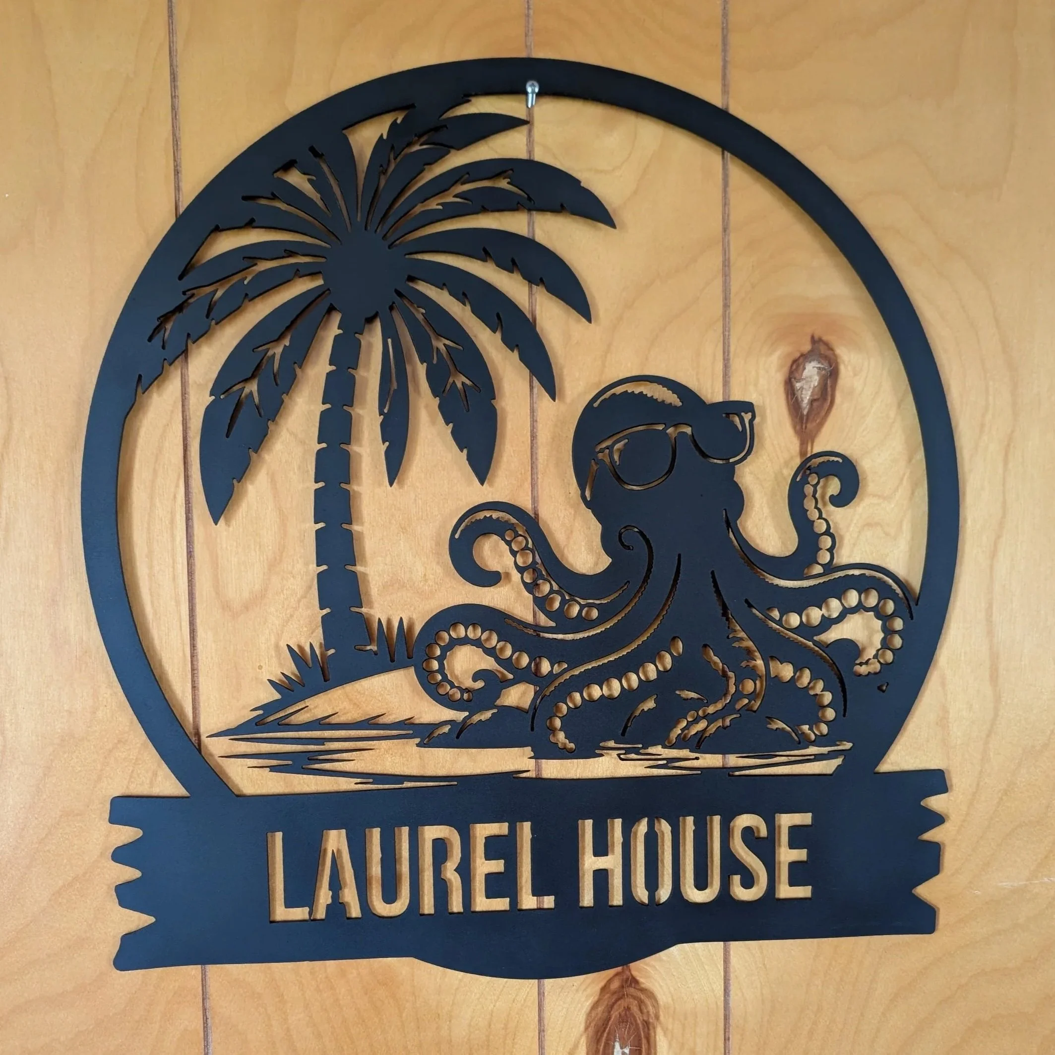 Custom black steel Laurel House octopus and palm tree sign cut with CNC plasma.