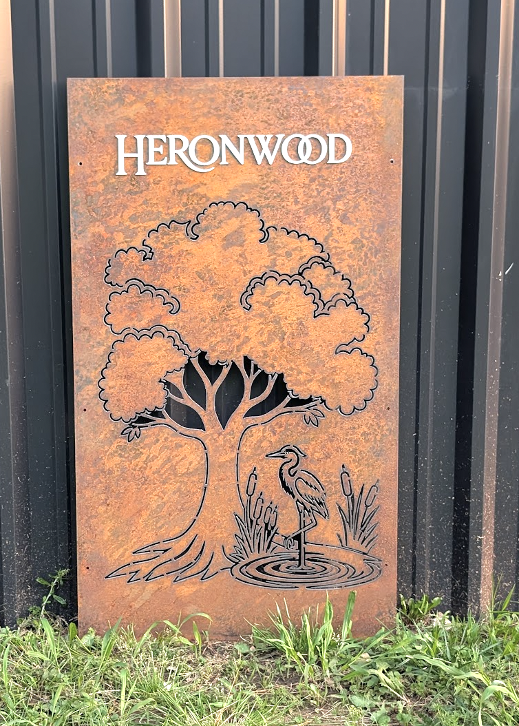 Custom CNC plasma cut Heronwood decorative steel panel featuring a tree and heron design with rust finish.