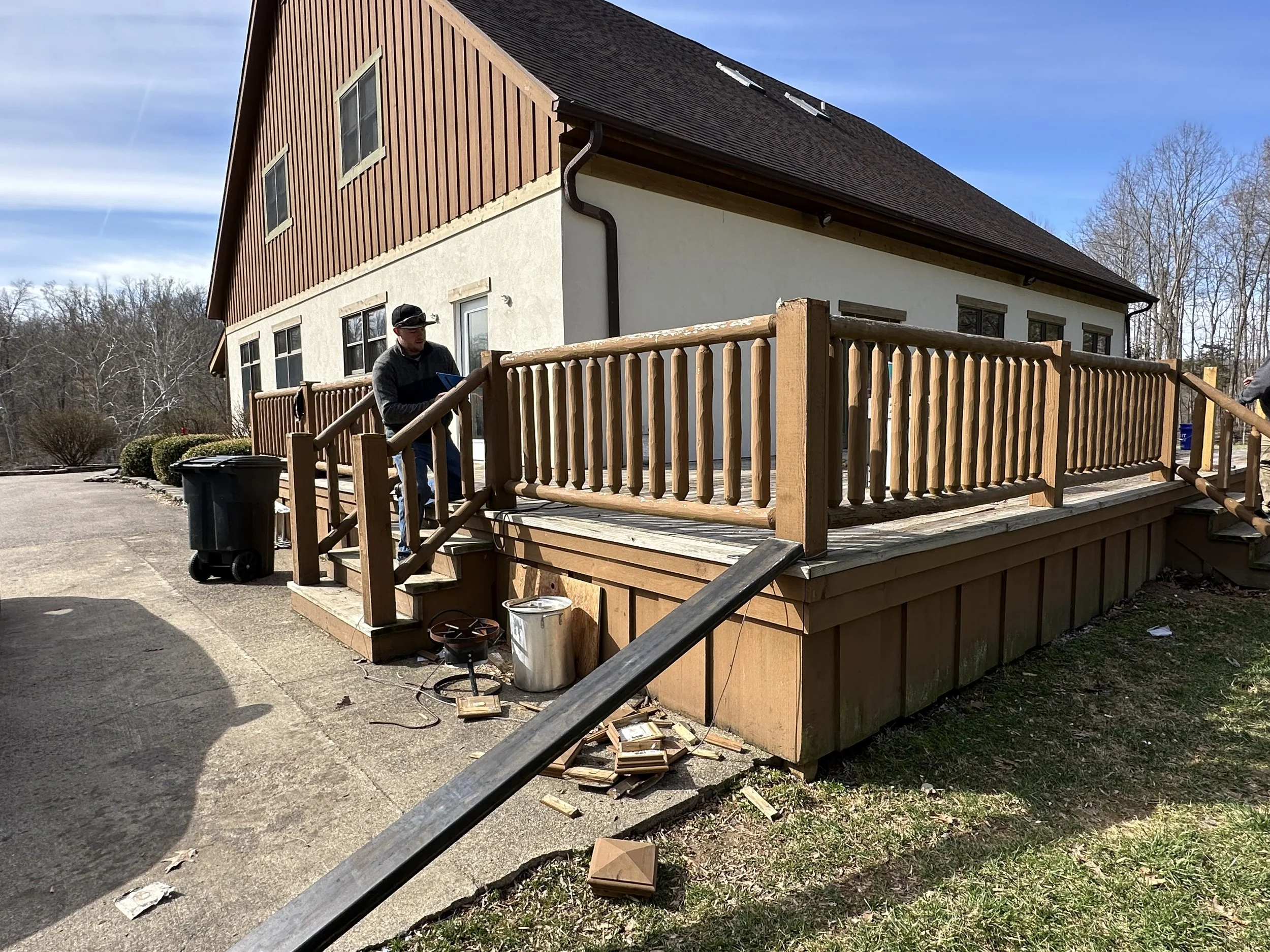 Original wood patio railing before replacement with custom metal cable railings.