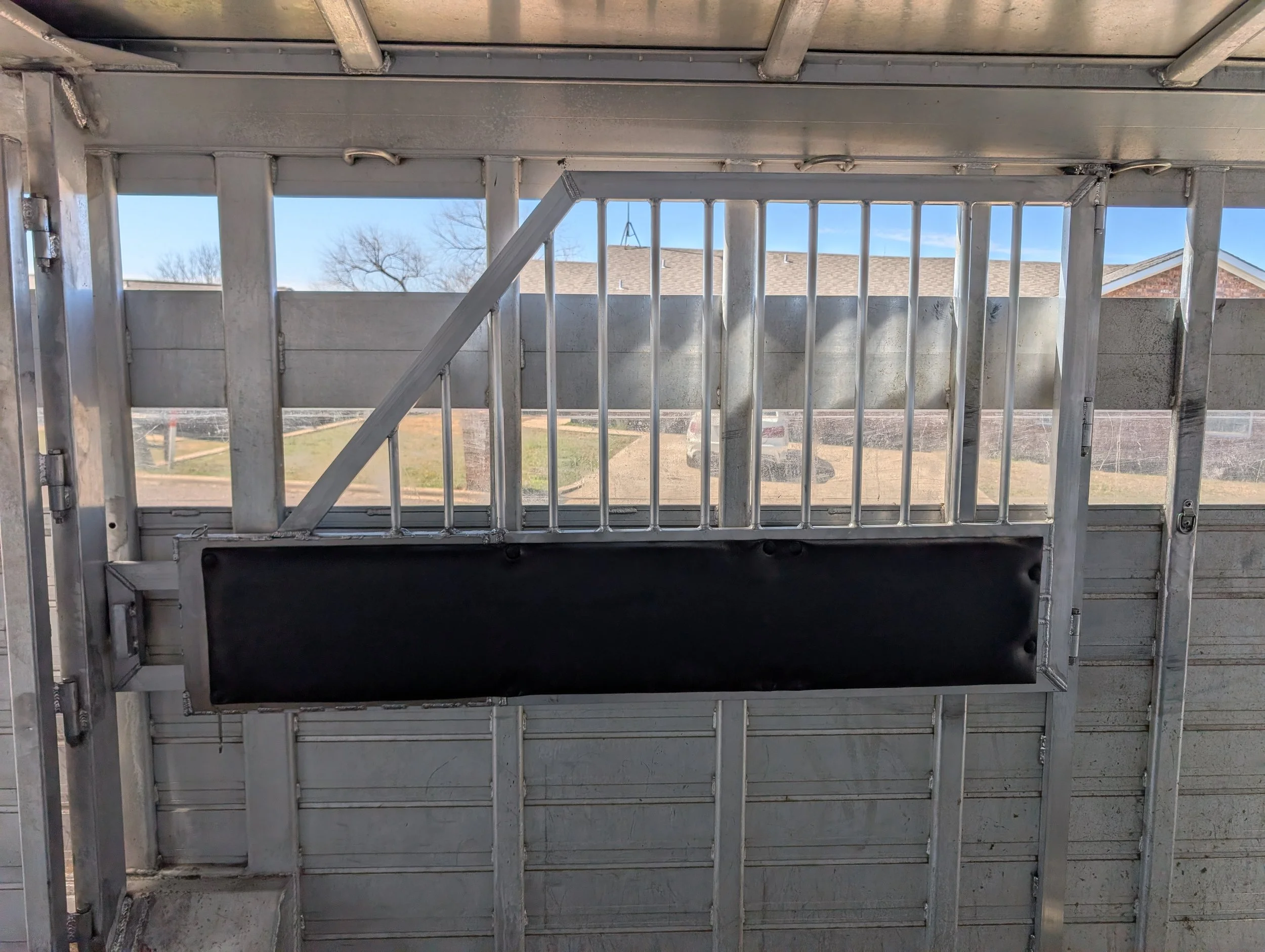 Padded steel horse divider fabricated and installed by JH Tig Works LLC.
