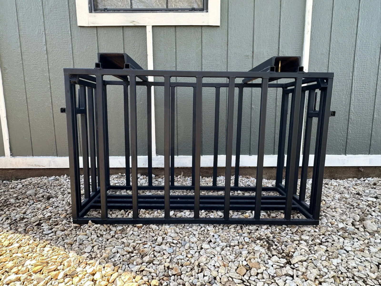 Custom steel pig chute fabricated by JH Tig Works LLC for livestock handling.