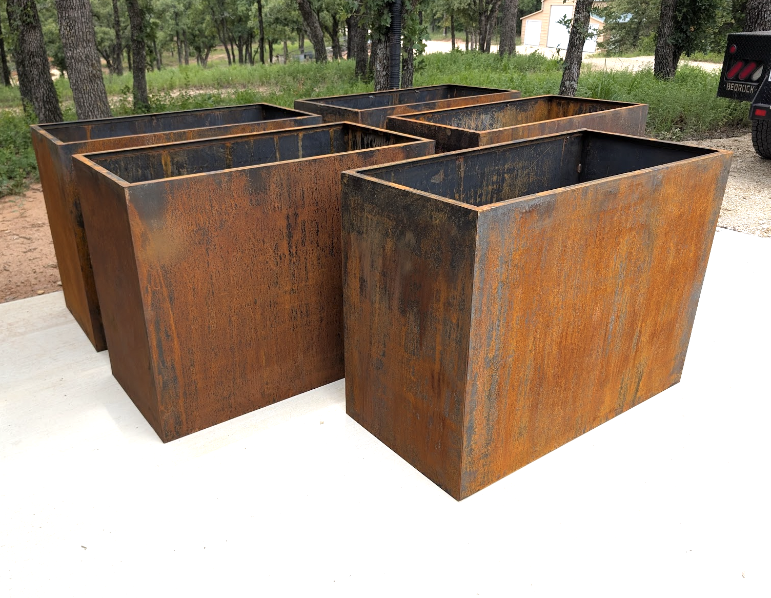 Custom fabricated Corten steel planter boxes with natural rust finish in North Texas