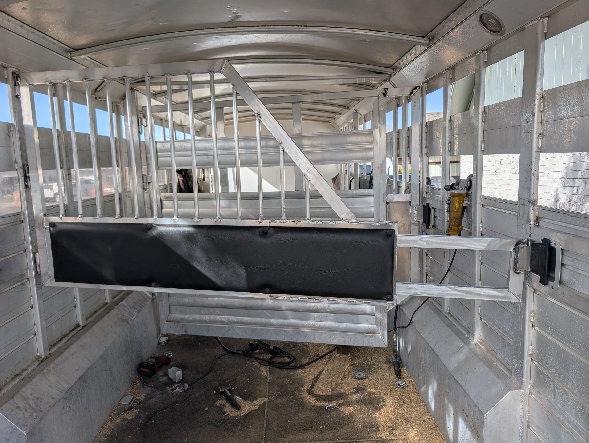 Custom horse trailer divider and interior framing fabricated during a livestock trailer conversion.