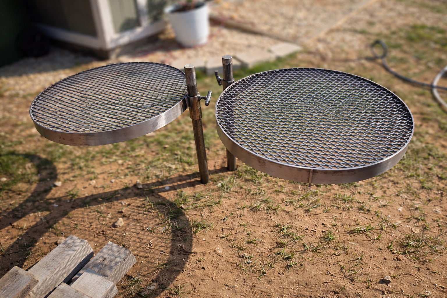 Custom adjustable steel grill grates fabricated for outdoor cooking and fire pit use, featuring a heavy-duty metal frame and mesh surface designed for durability, heat control, and long-term outdoor use.