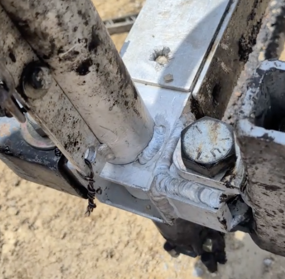 Aluminum trailer frame repair with welded reinforcement around mounting hardware.