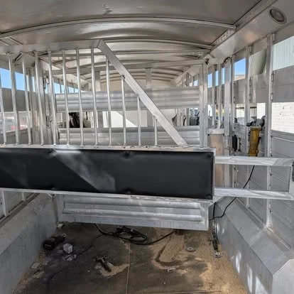 Custom aluminum horse trailer dividers fabricated during a livestock trailer conversion.