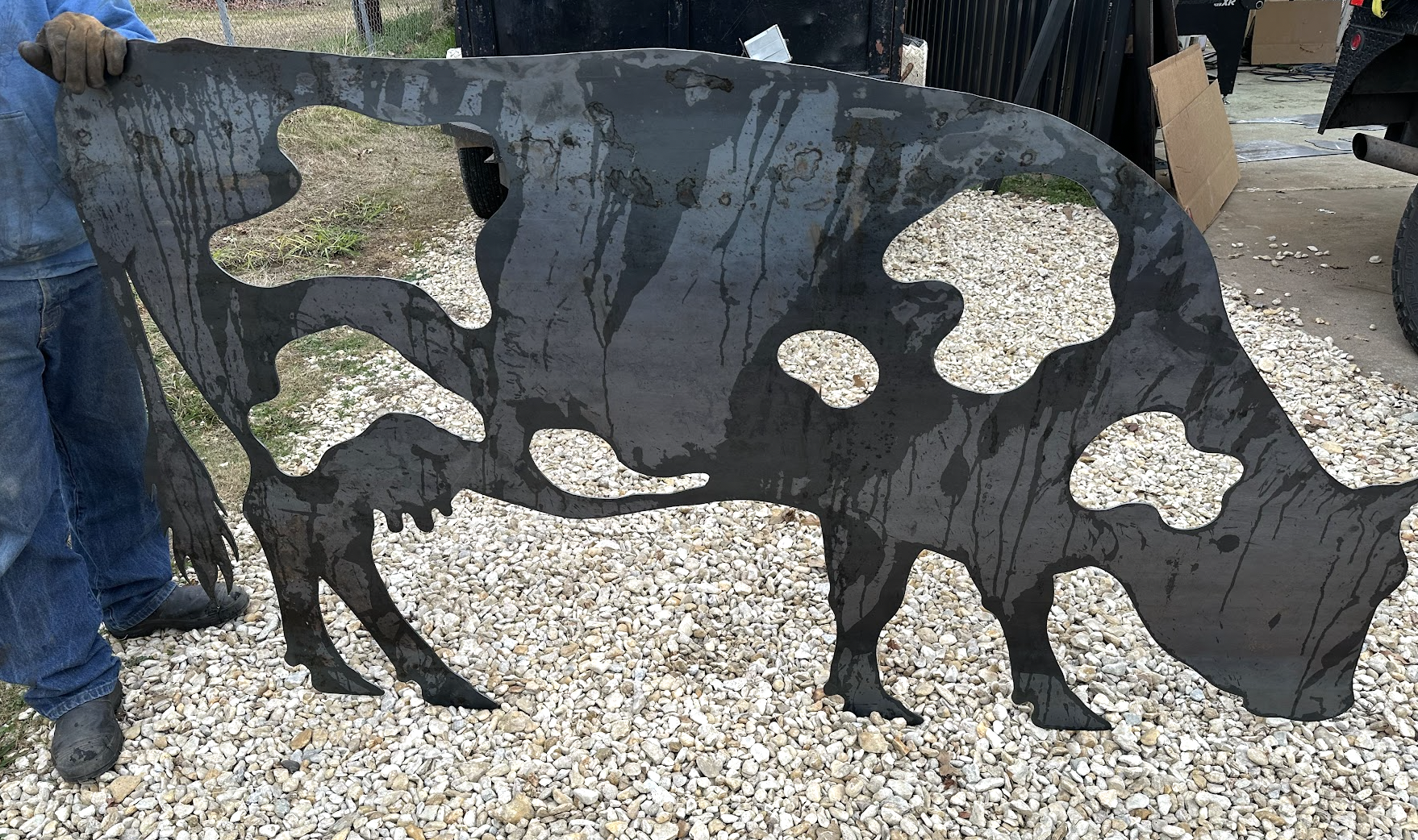 Custom CNC plasma cut steel cow silhouette with detailed cutout markings fabricated by JH Tig Works.