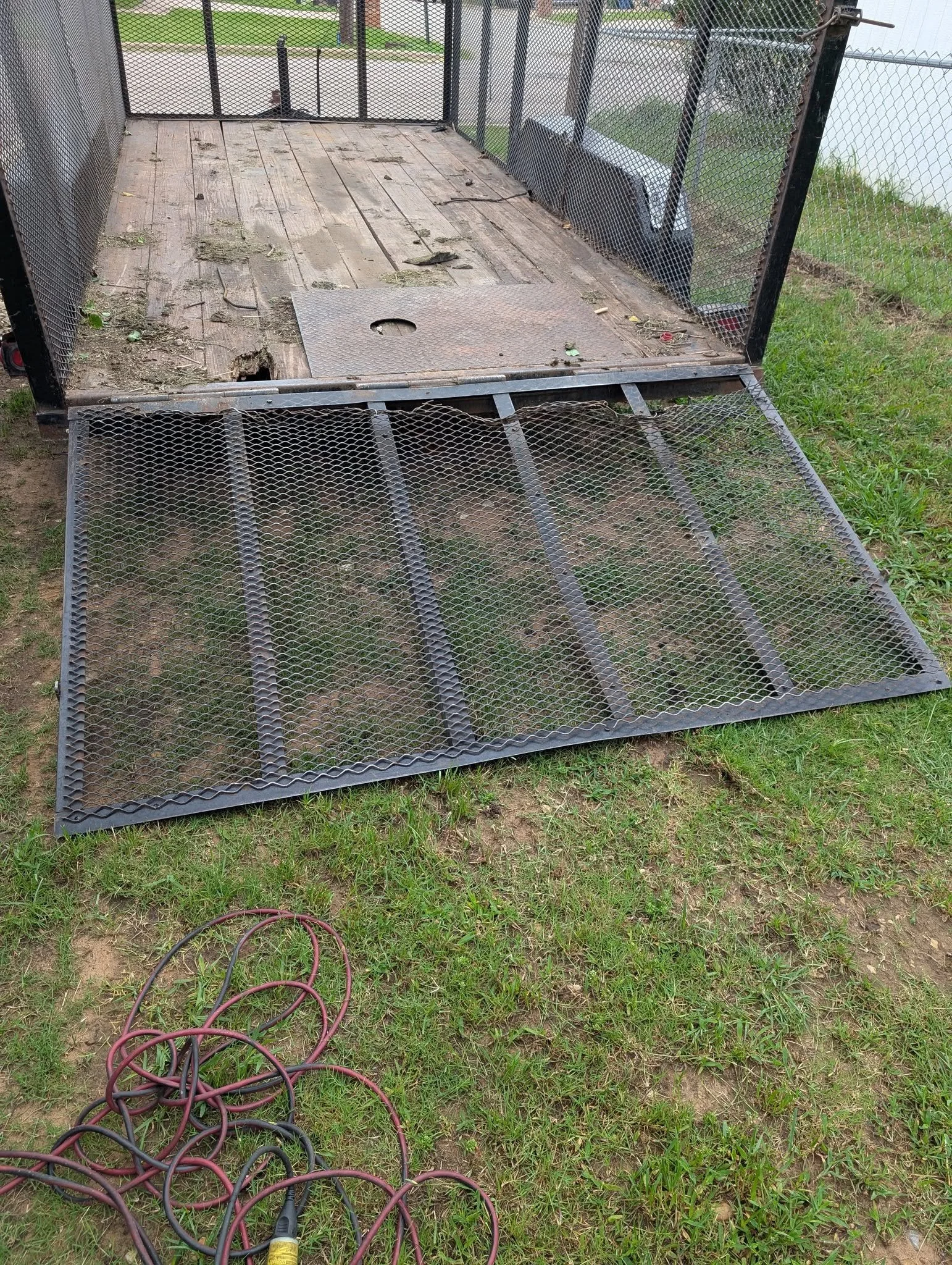 Damaged landscape trailer ramp before repair and welding by JH Tig Works LLC in North Texas.