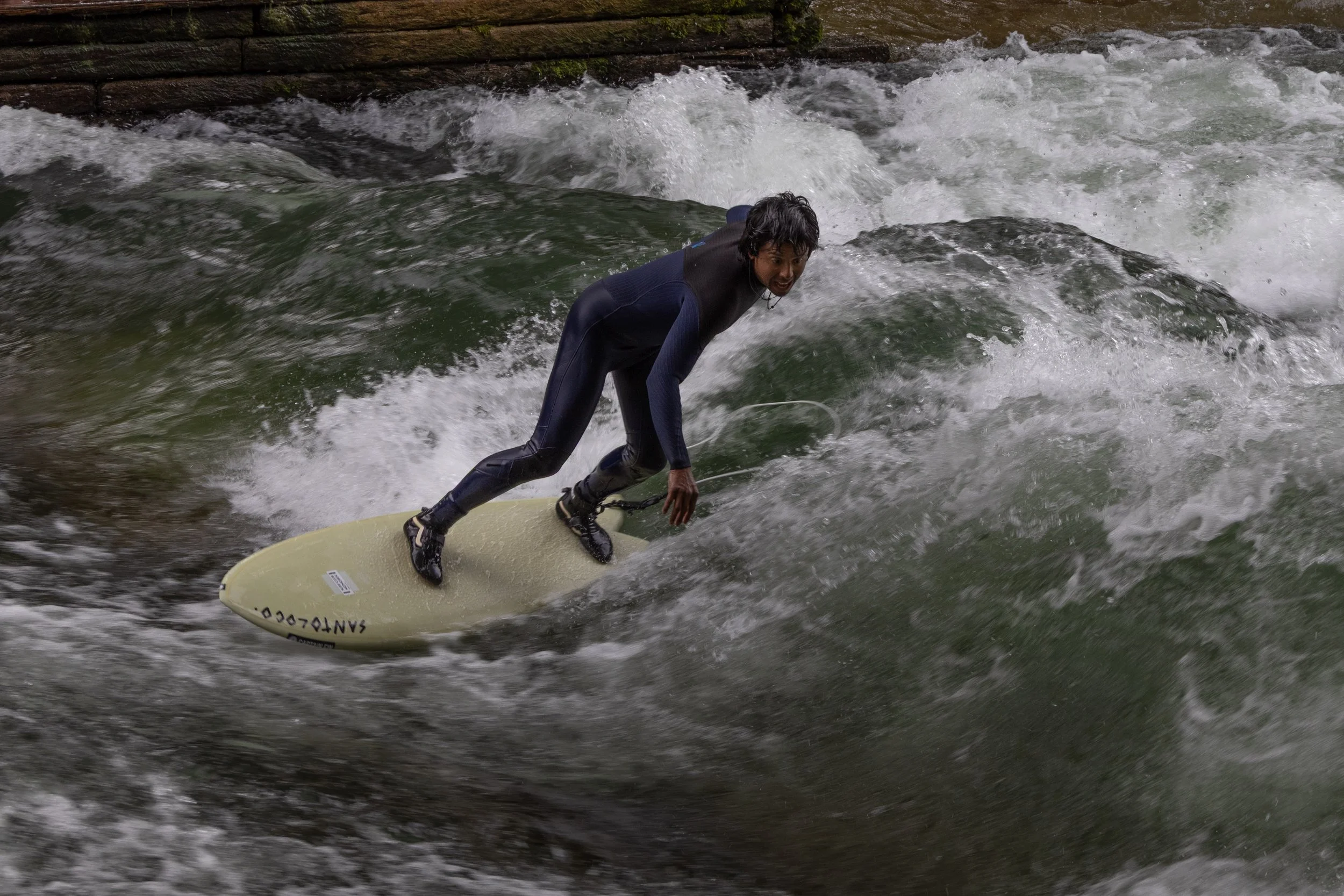 Munich, Germany | A surfer rides the powerful Eisbach wave. 