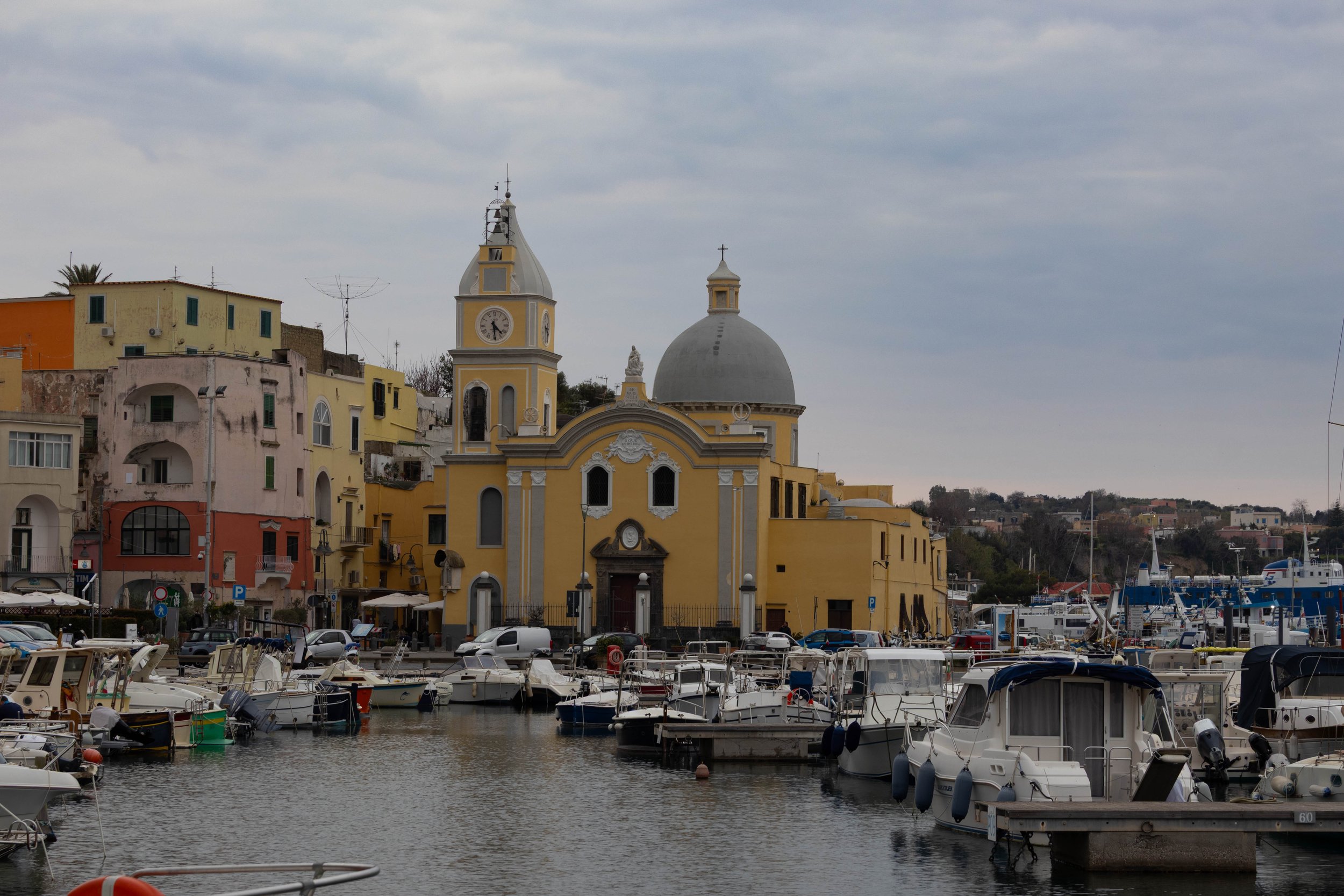 Procida, Italy | Boats fill the harbor in front of the church of Santa Maria della Pieta' in Procida. 