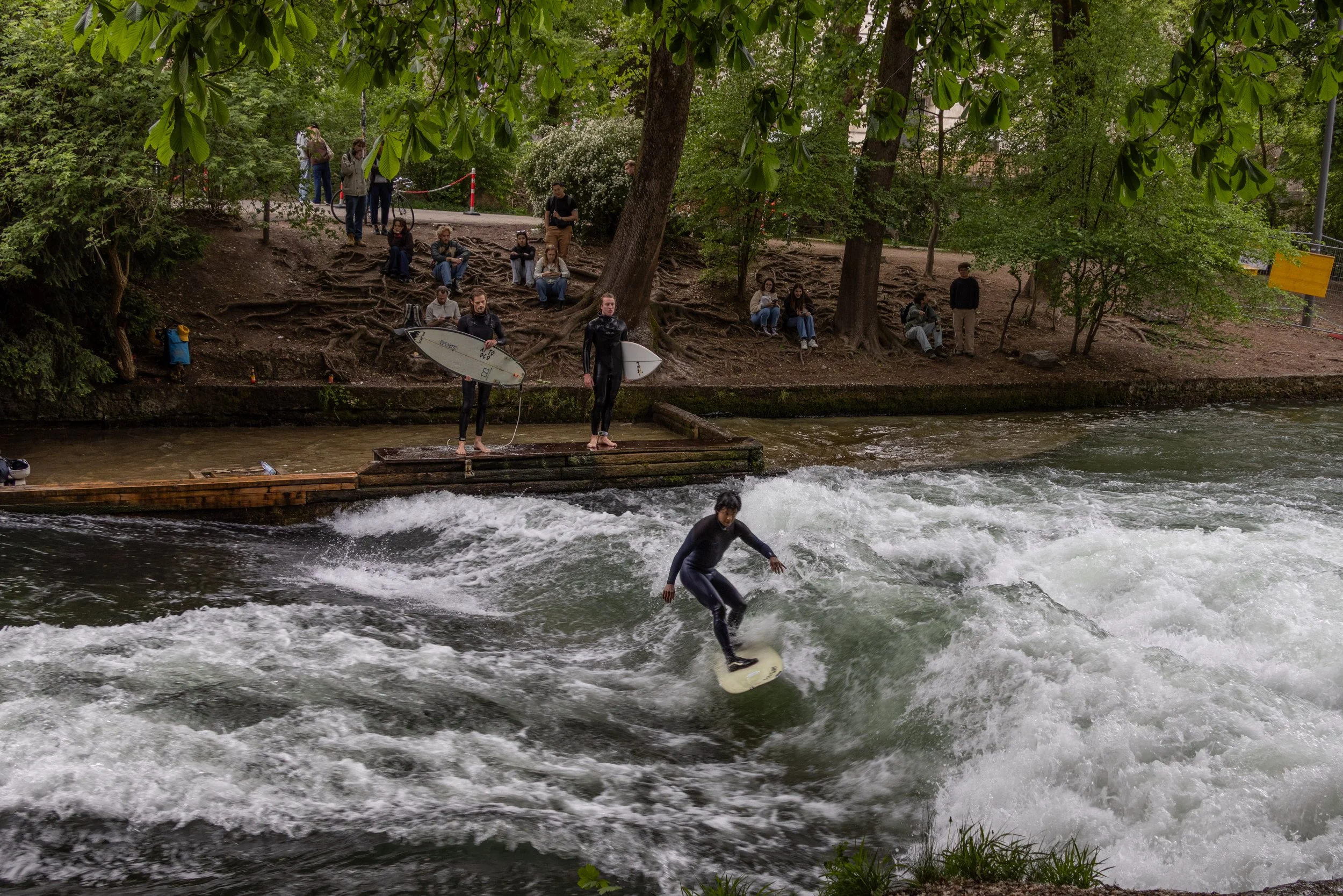 Munich, Germany | A surfer rides the Eisbach wave.