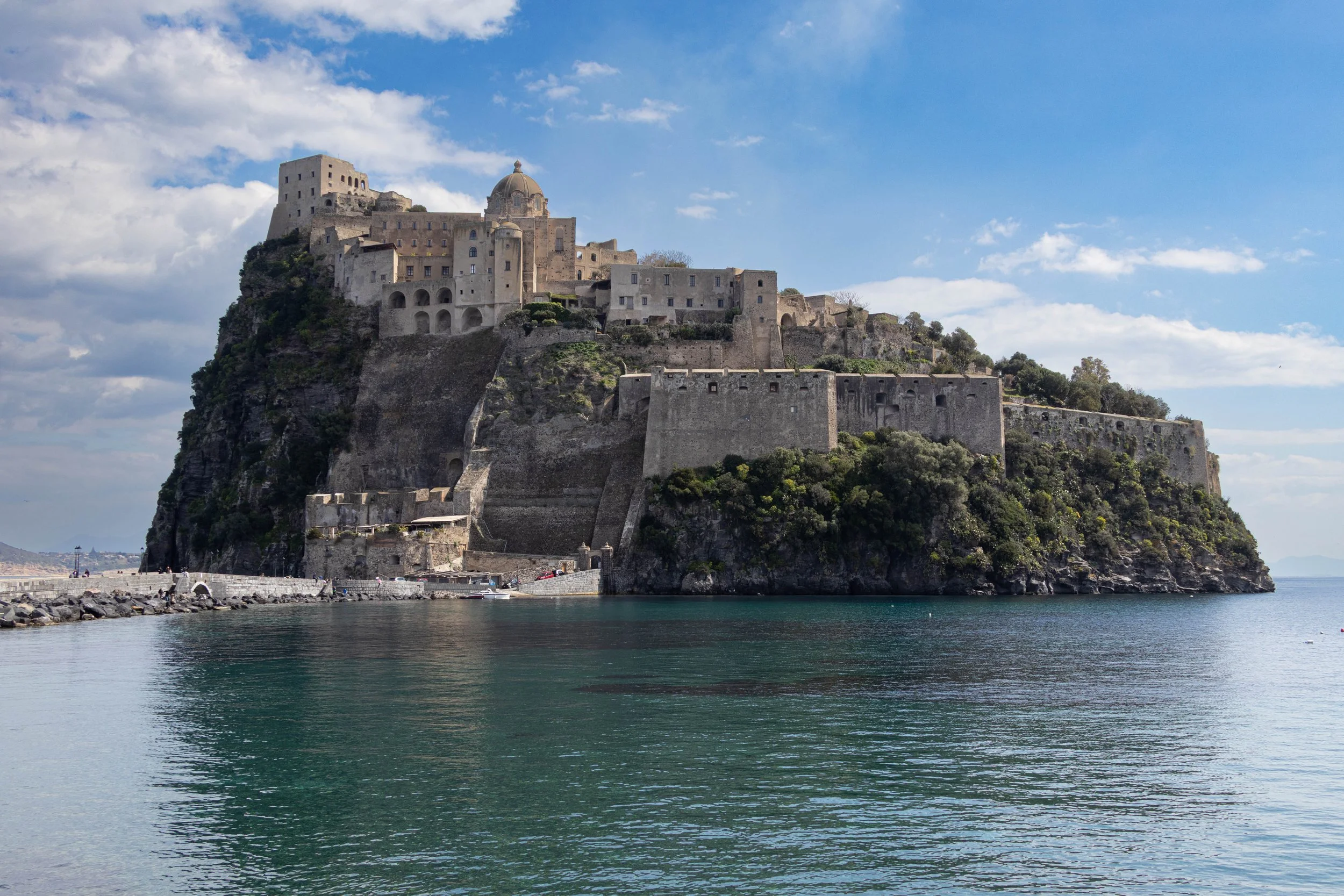 Ischia, Italy | Castello Aragonese rises above the turquoise waters along the coast of Ischia. 