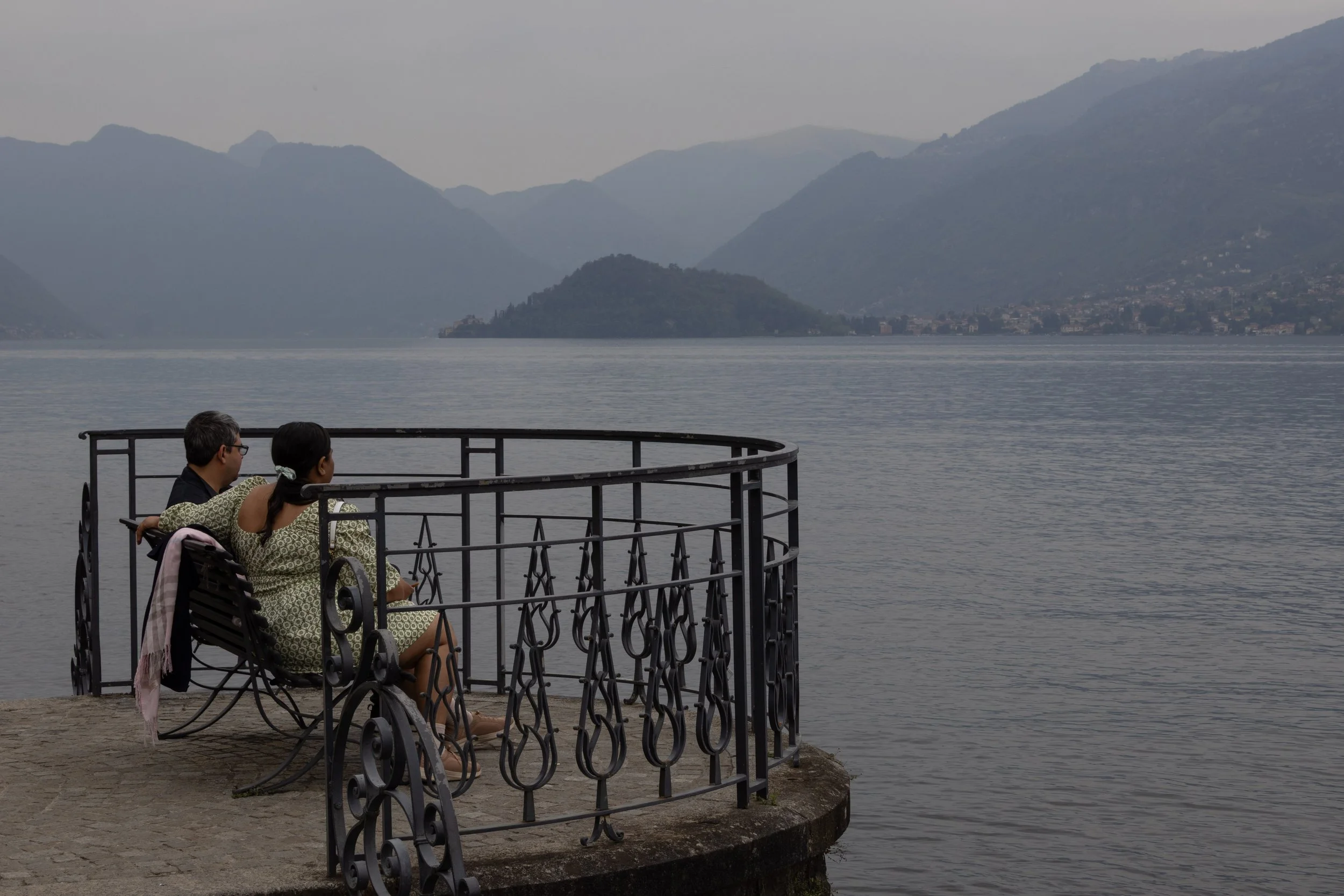 Bellagio, Italy | A quiet moment overlooking the calm waters and hazy mountains of Lake Como. 
