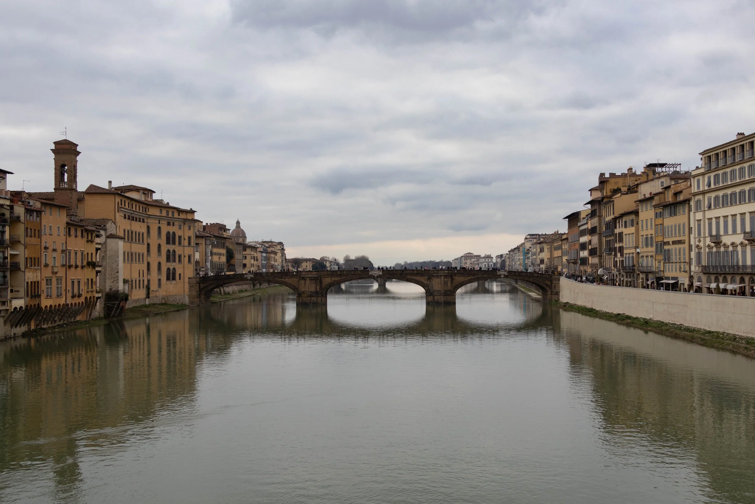 Florence, Italy | Daytime view of the Arno River and Florence's historic bridges. 