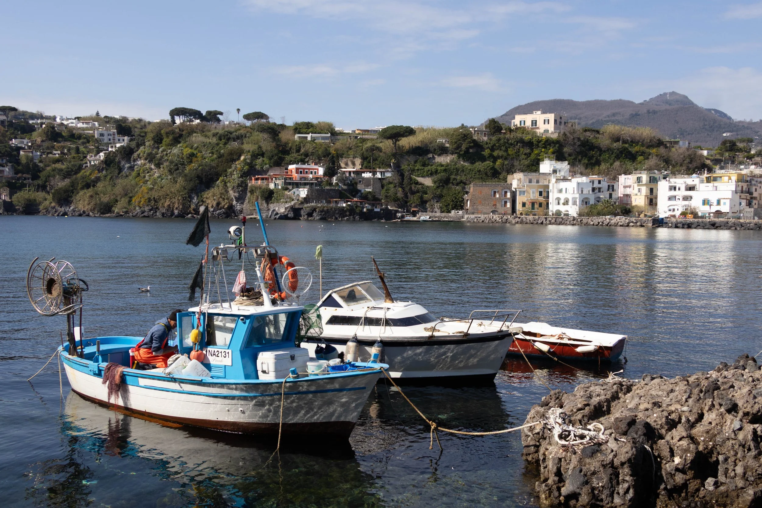 Ischia, Italy | A colorful fishing boat rests along the quiet waterfront of Ischia. 
