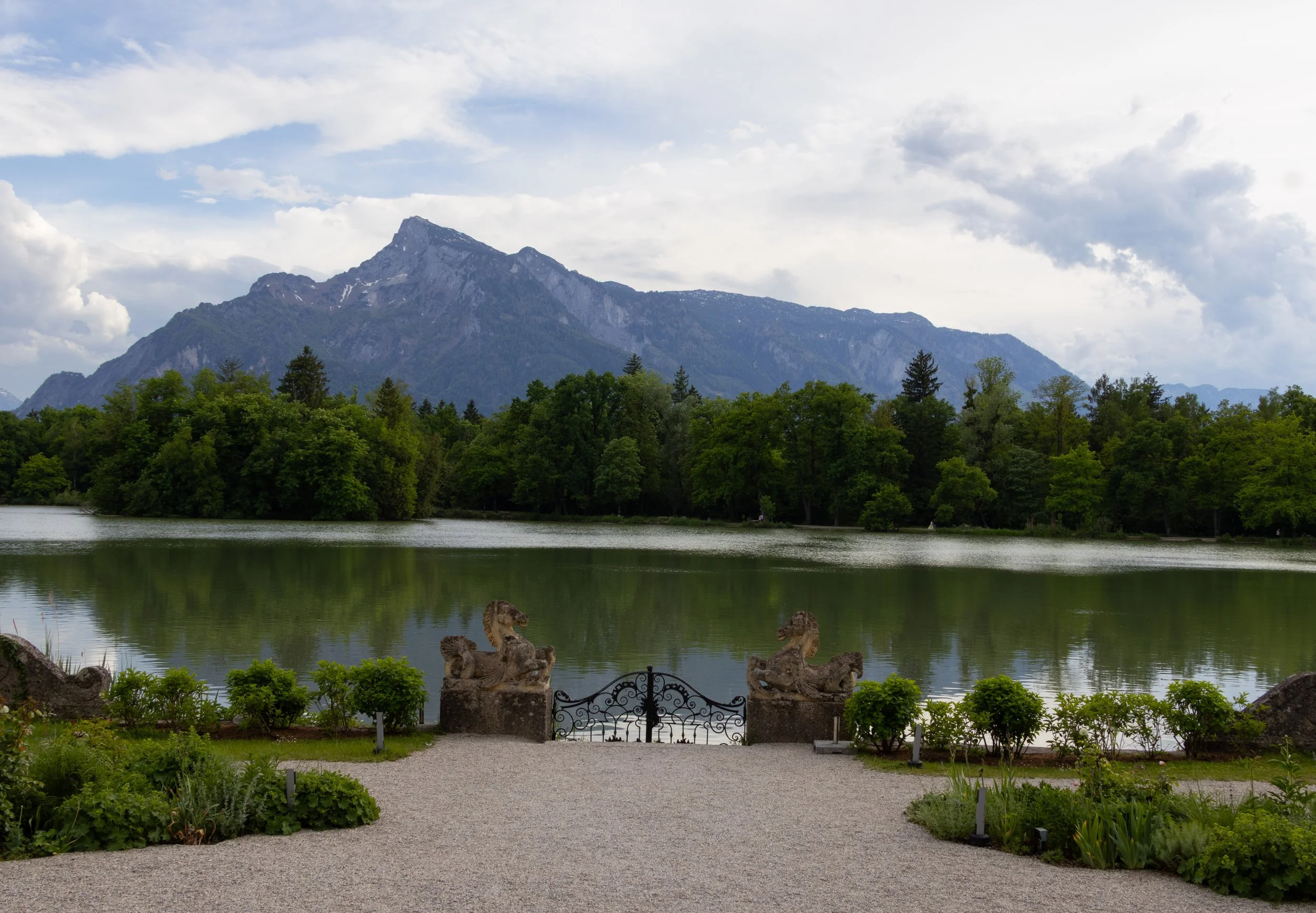 Salzburg, Austria | A mountain rising beyond the lake on the historic grounds featured in The Sound of Music Film. 