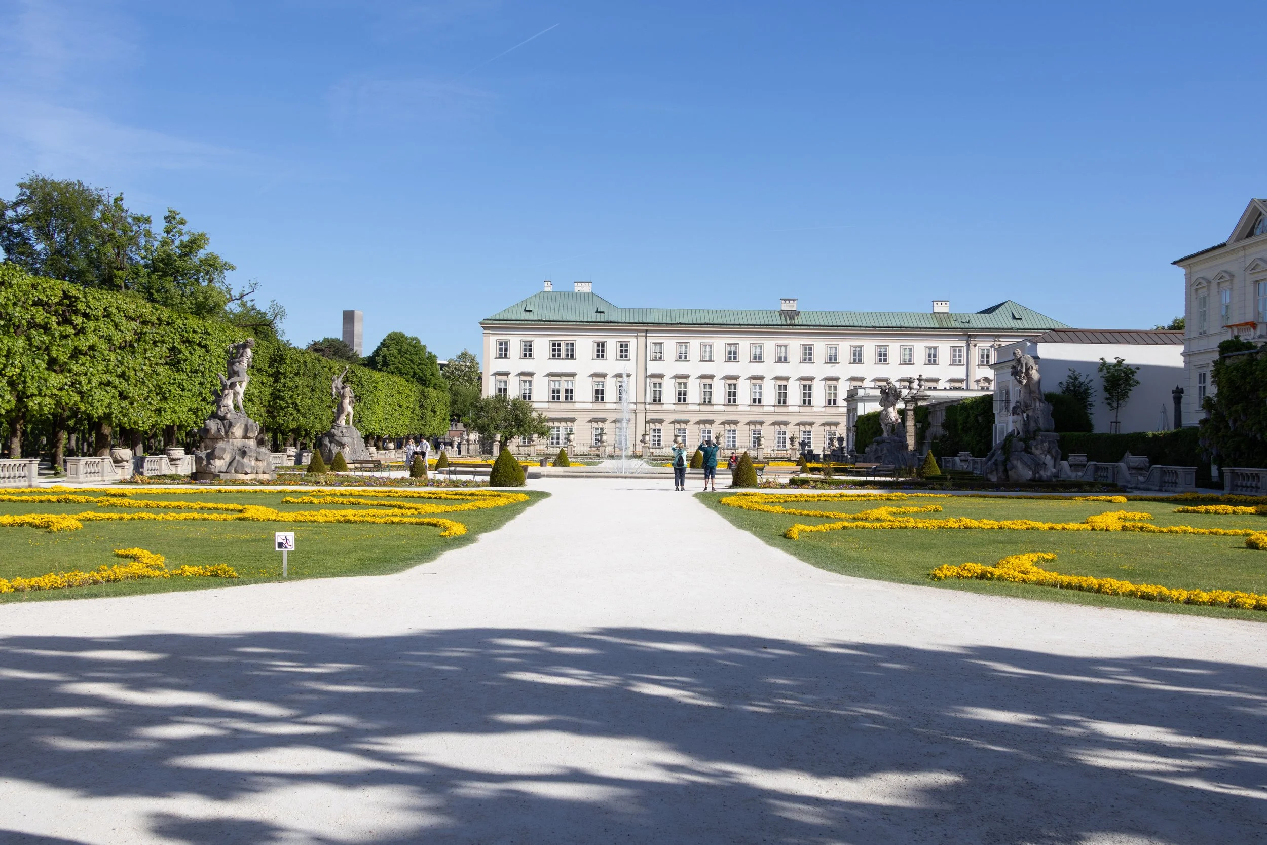 Salzburg, Austria | Flower gardens and pathways leading toward Mirabell Palace. 