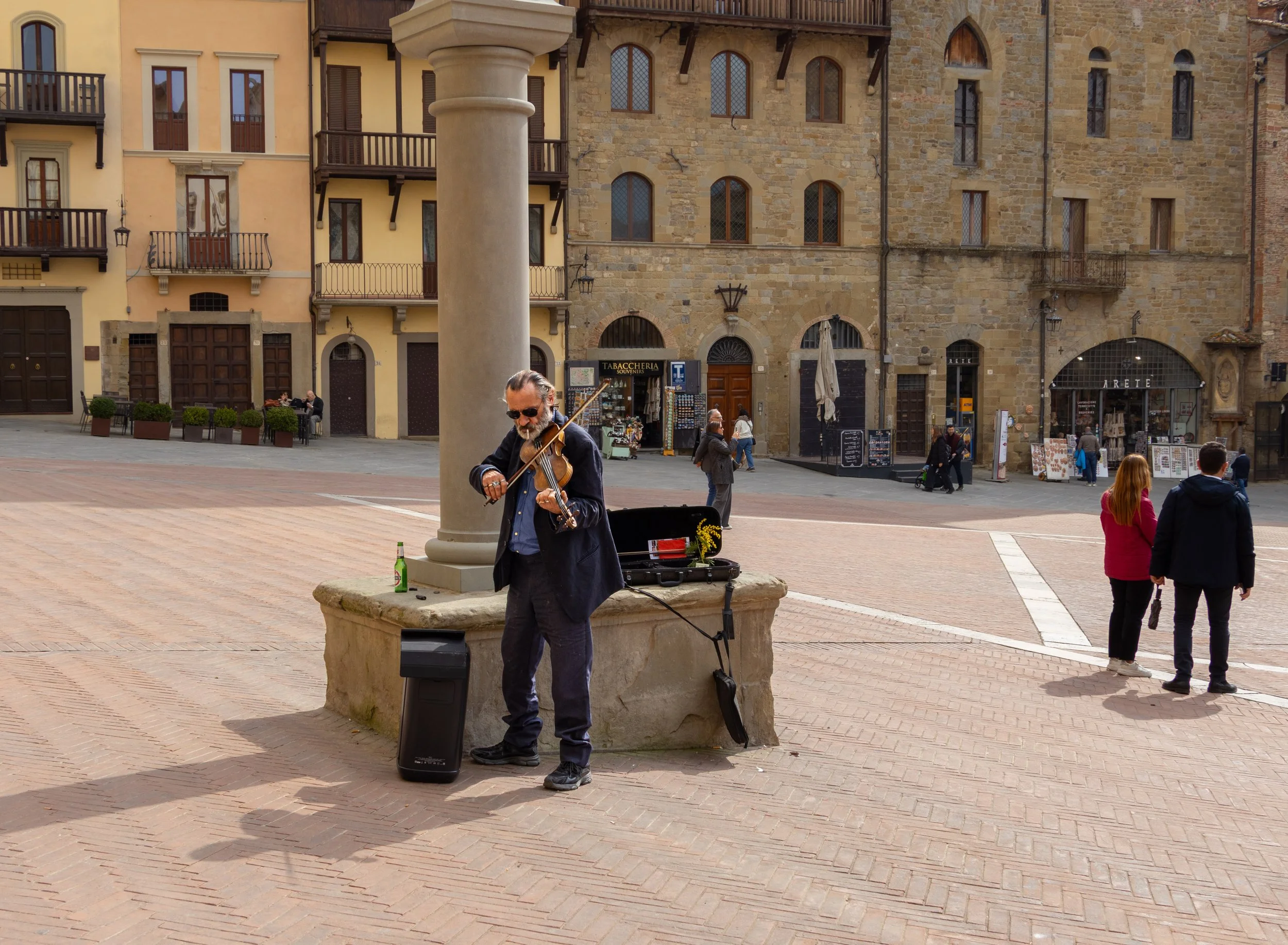 Arezzo, Italy | A street musician performs in Piazza Grande, adding music and atmosphere to the historic heart or Arezzo.